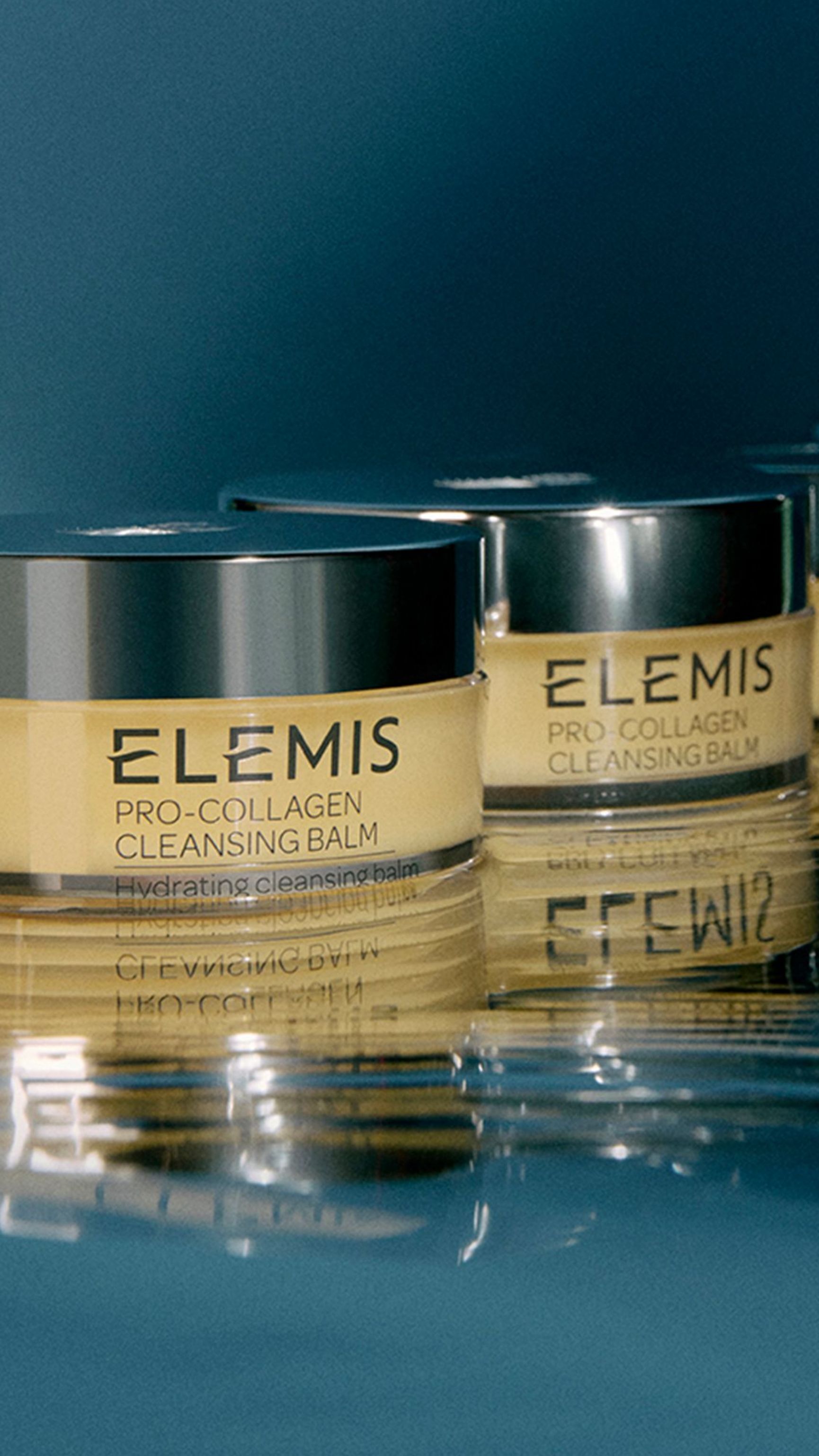 Woman holding an open jar of Elemis Pro-Collagen Cleansing Balm.