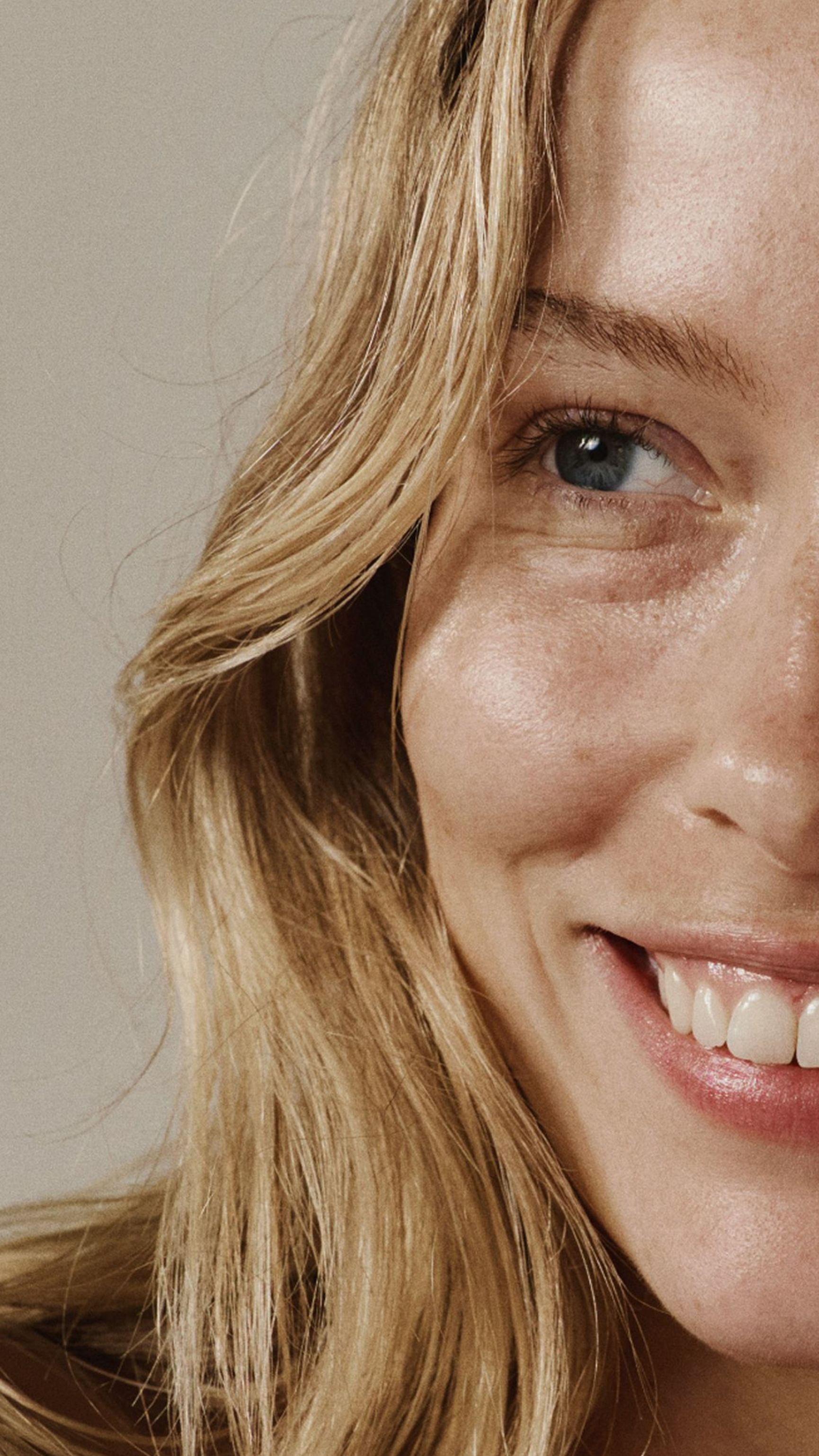 Smiling blonde woman with freckles and "TRANSFORM THROUGH CONSISTENCY" text.