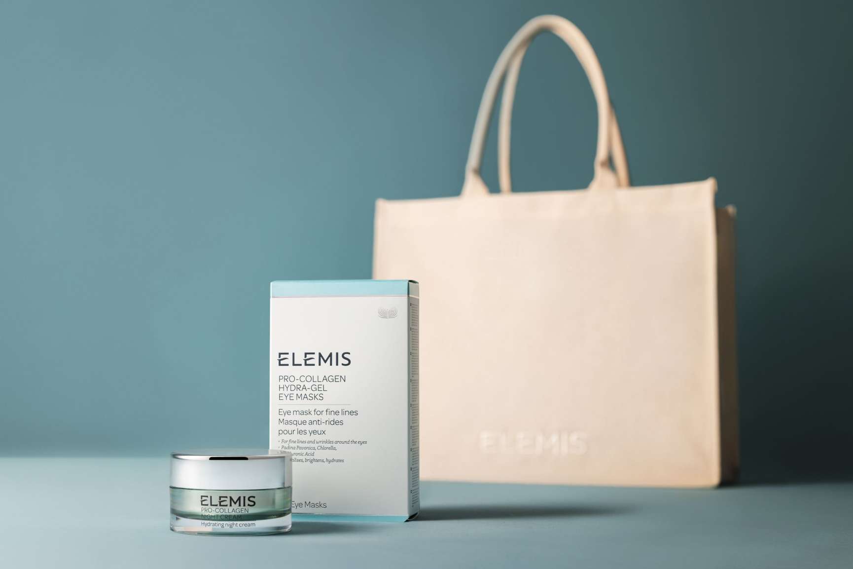 Cream tote bag with product in front on a light blue background.