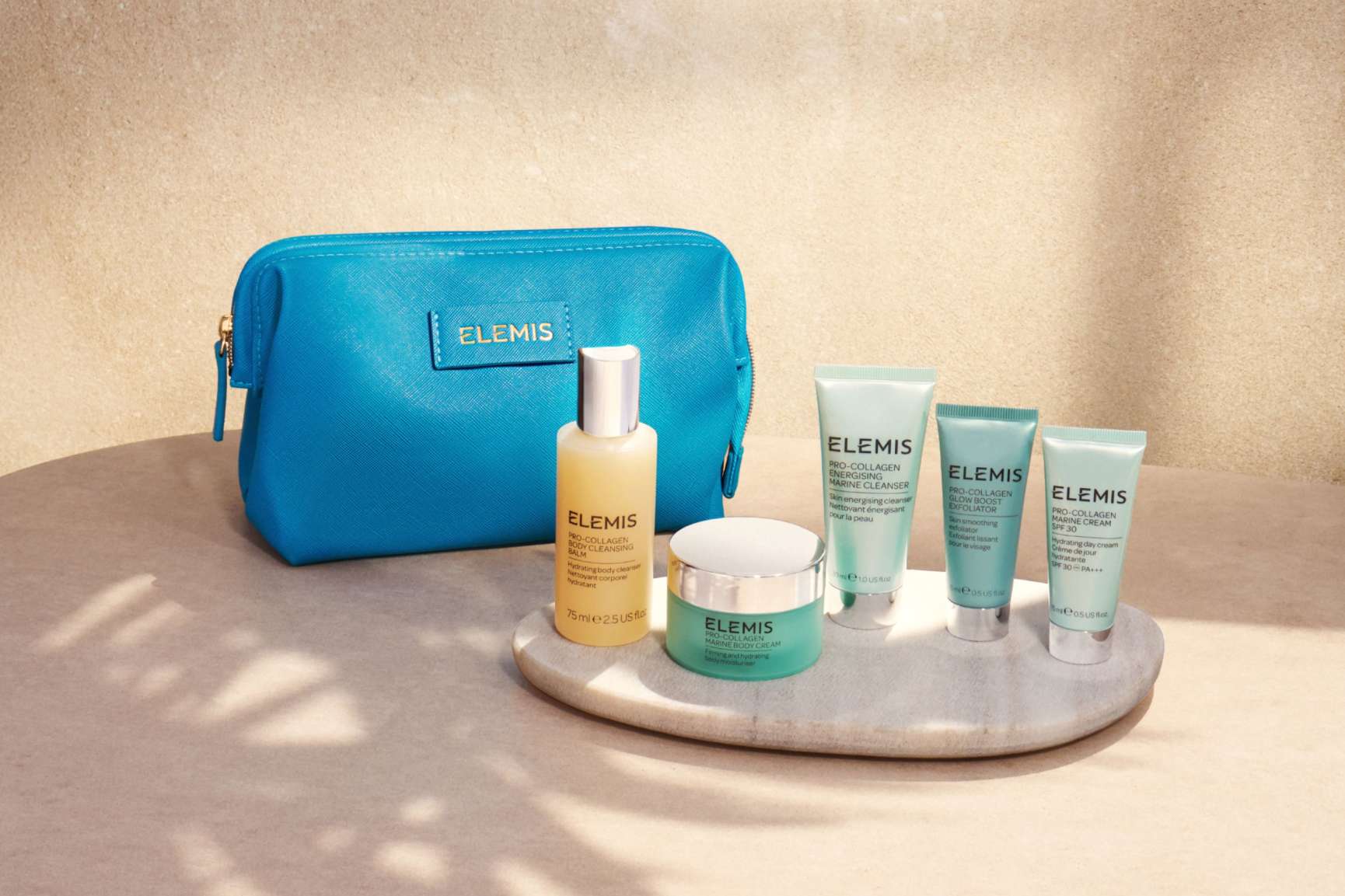 ELEMIS skincare set with a blue cosmetic bag and five skincare products.