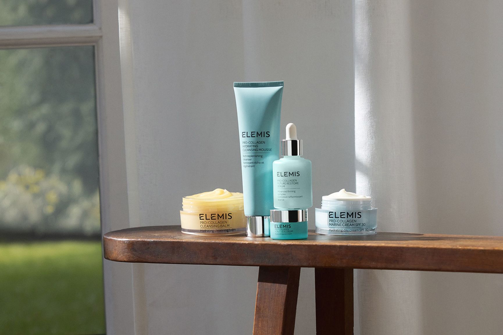 Set of 3 Pro-Collagen product jars stacked up in the sand