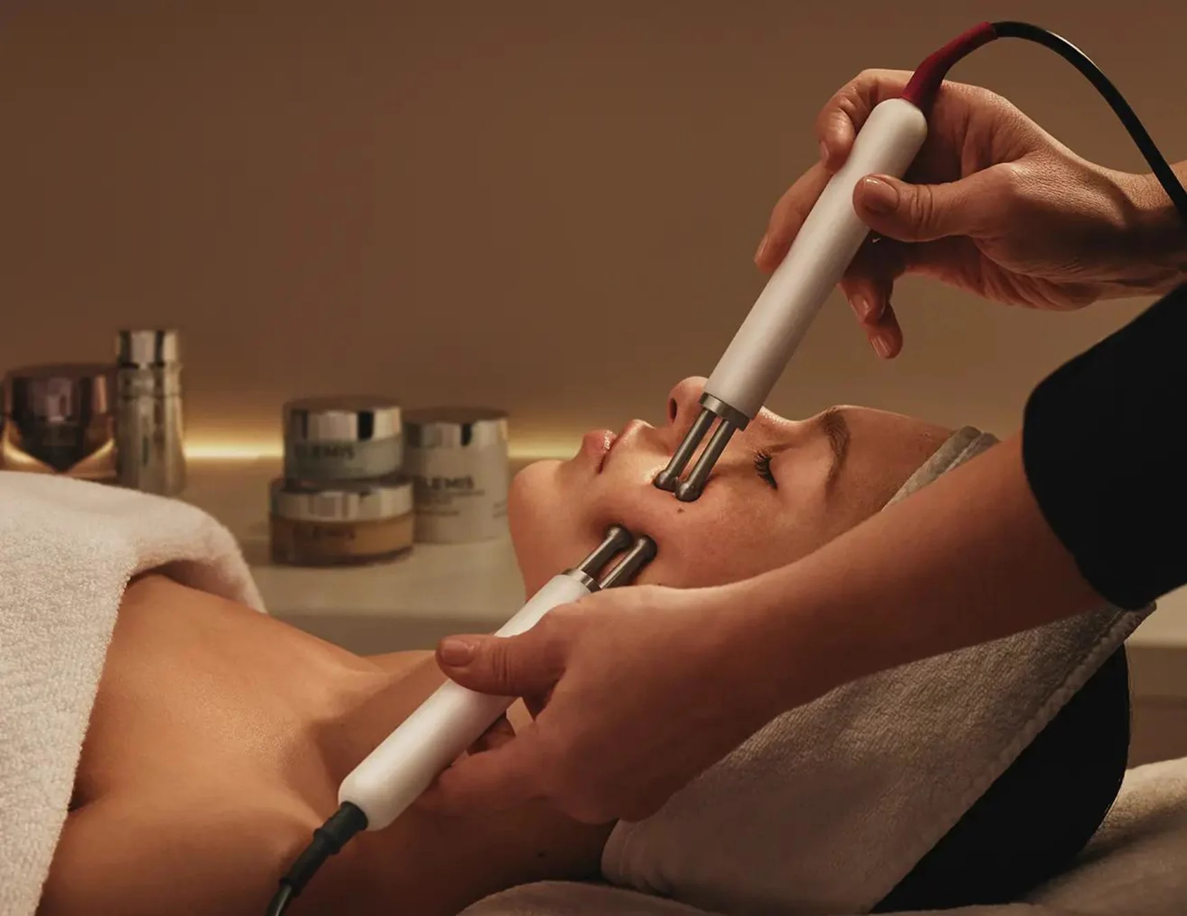 Woman receiving a microcurrent facial.
