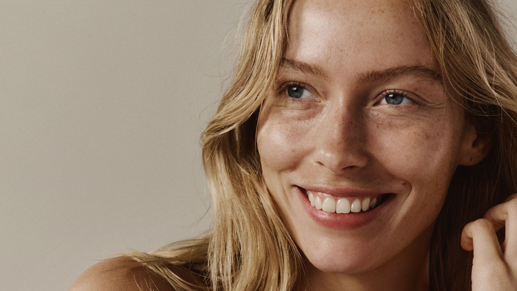 Smiling blonde woman with freckles and "TRANSFORM THROUGH CONSISTENCY" text.
