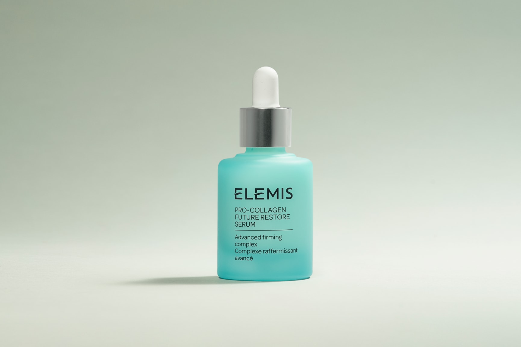 Elemis Pro-Collagen Future Restore Serum in a light blue dropper bottle with a drop of liquid.