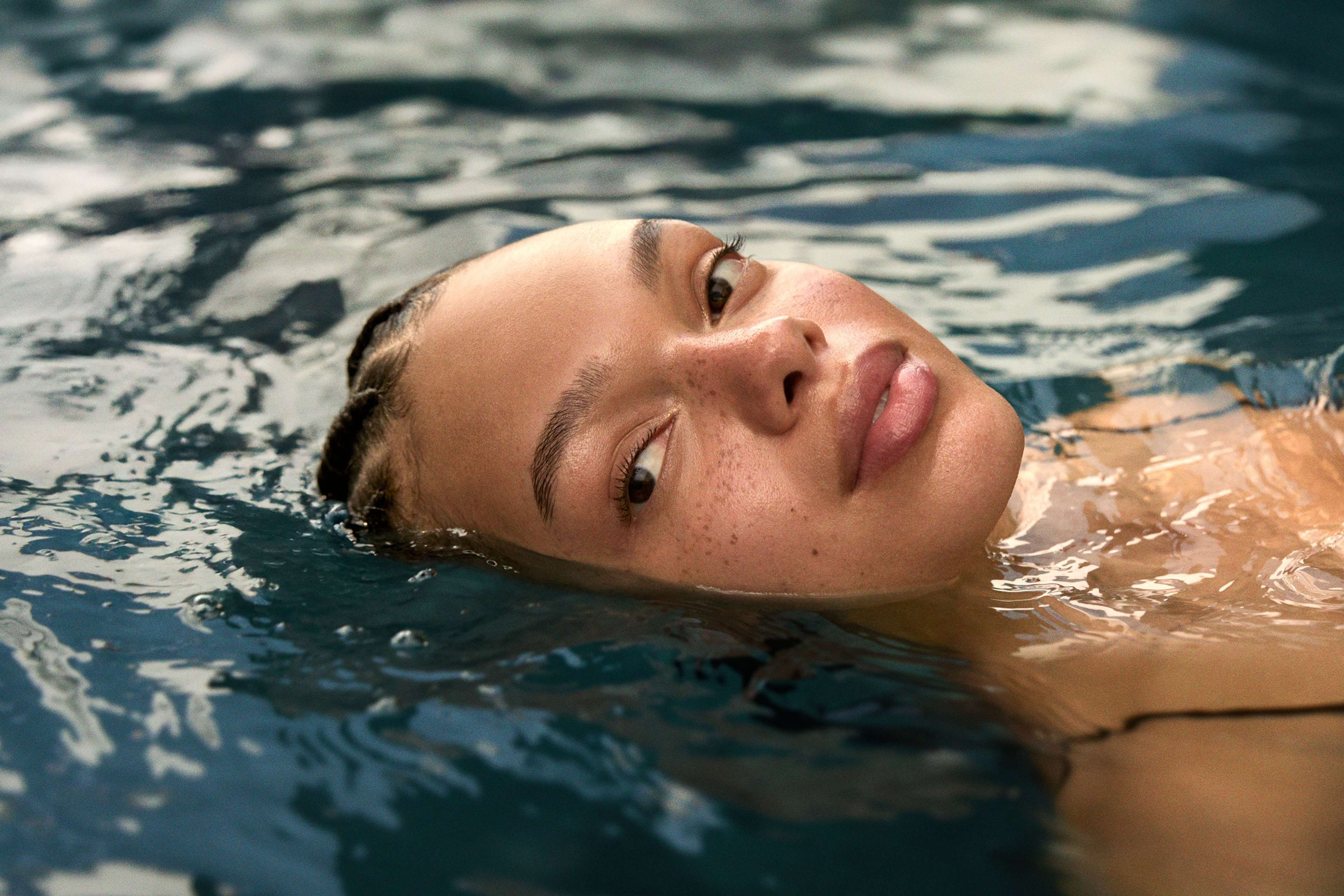 Woman in a shower with a Pro-Collagen Body Cleansing Balm