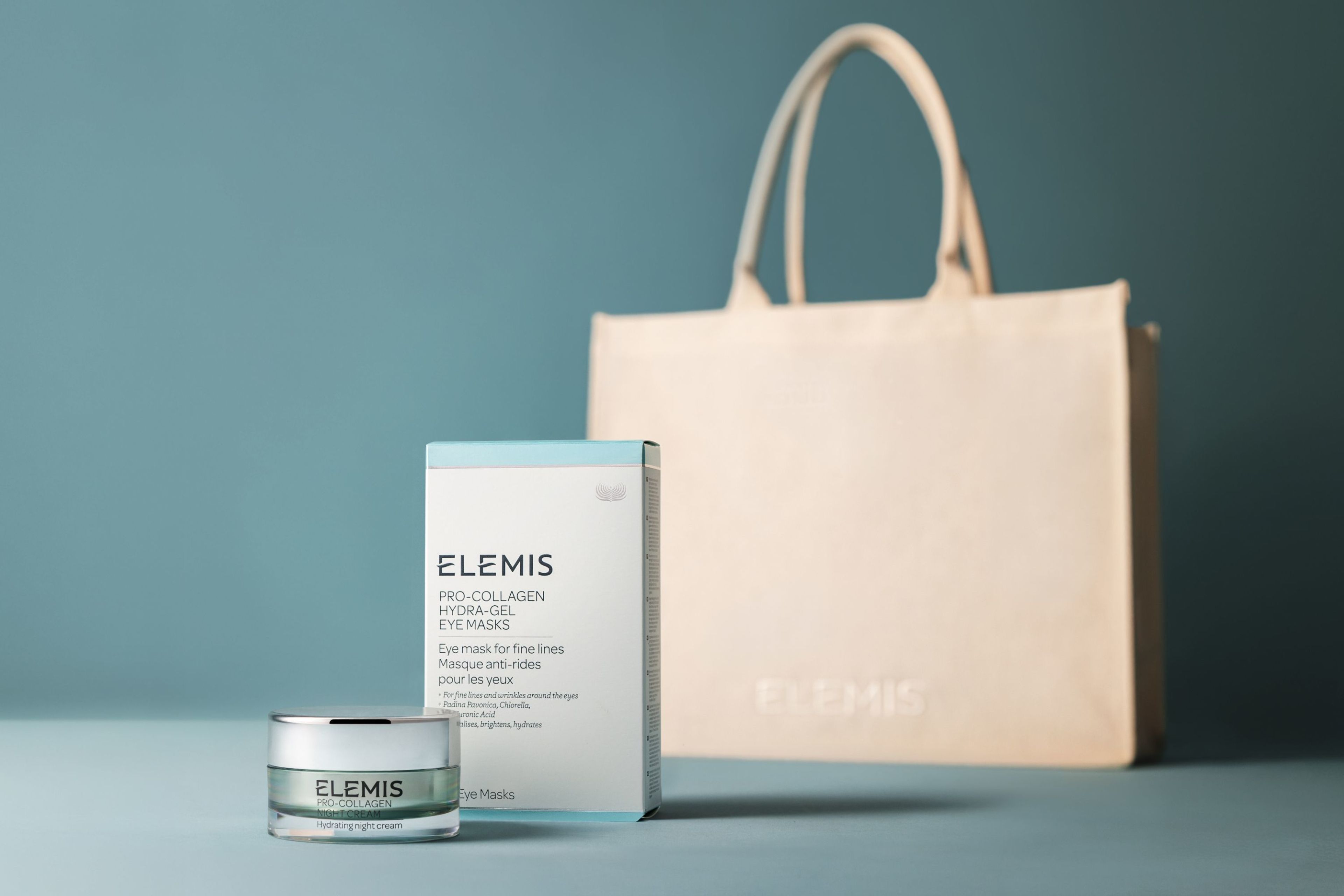 Cream tote bag with product in front on a light blue background.