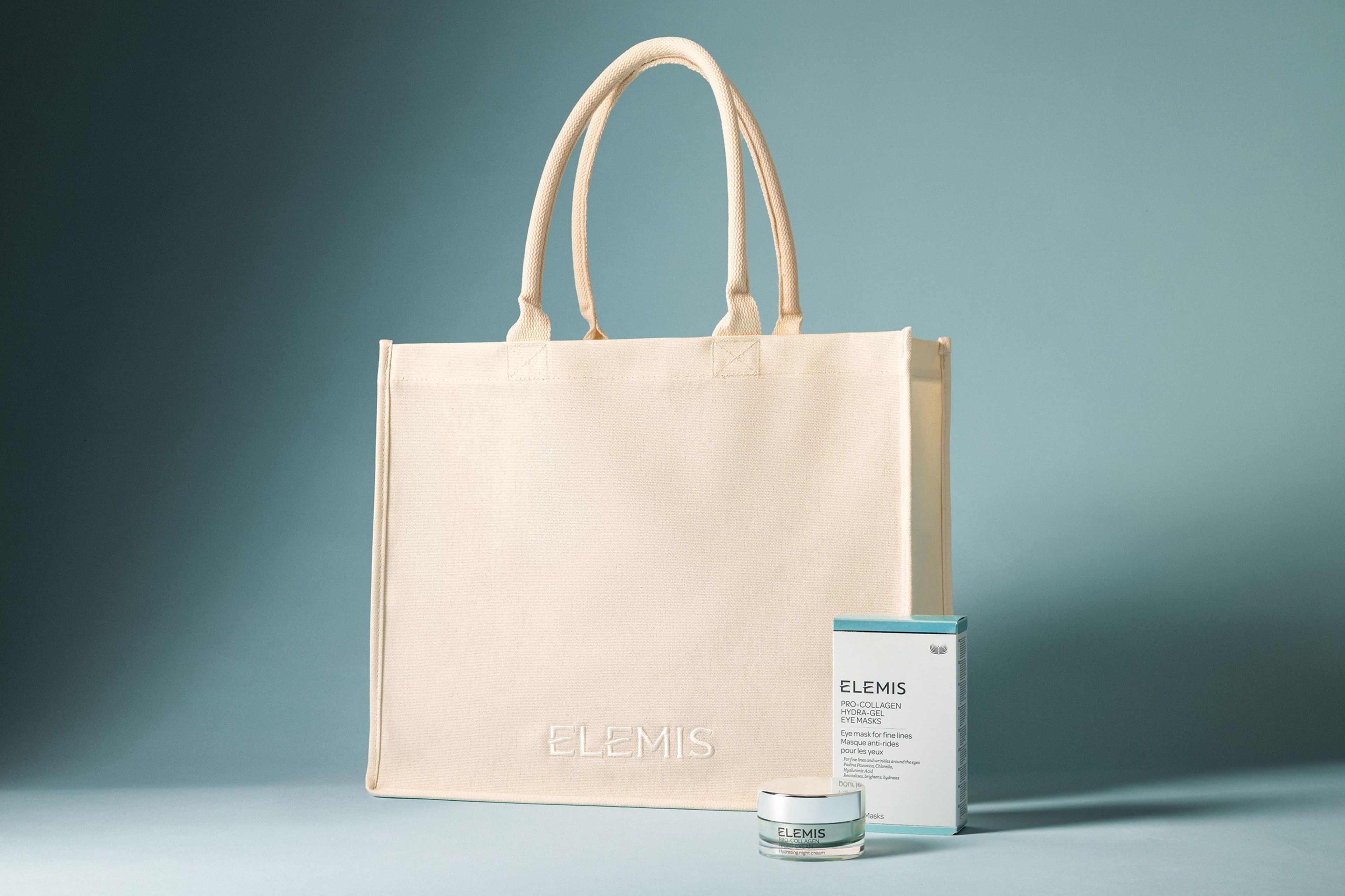 Cream tote bag with product in front on a light blue background.