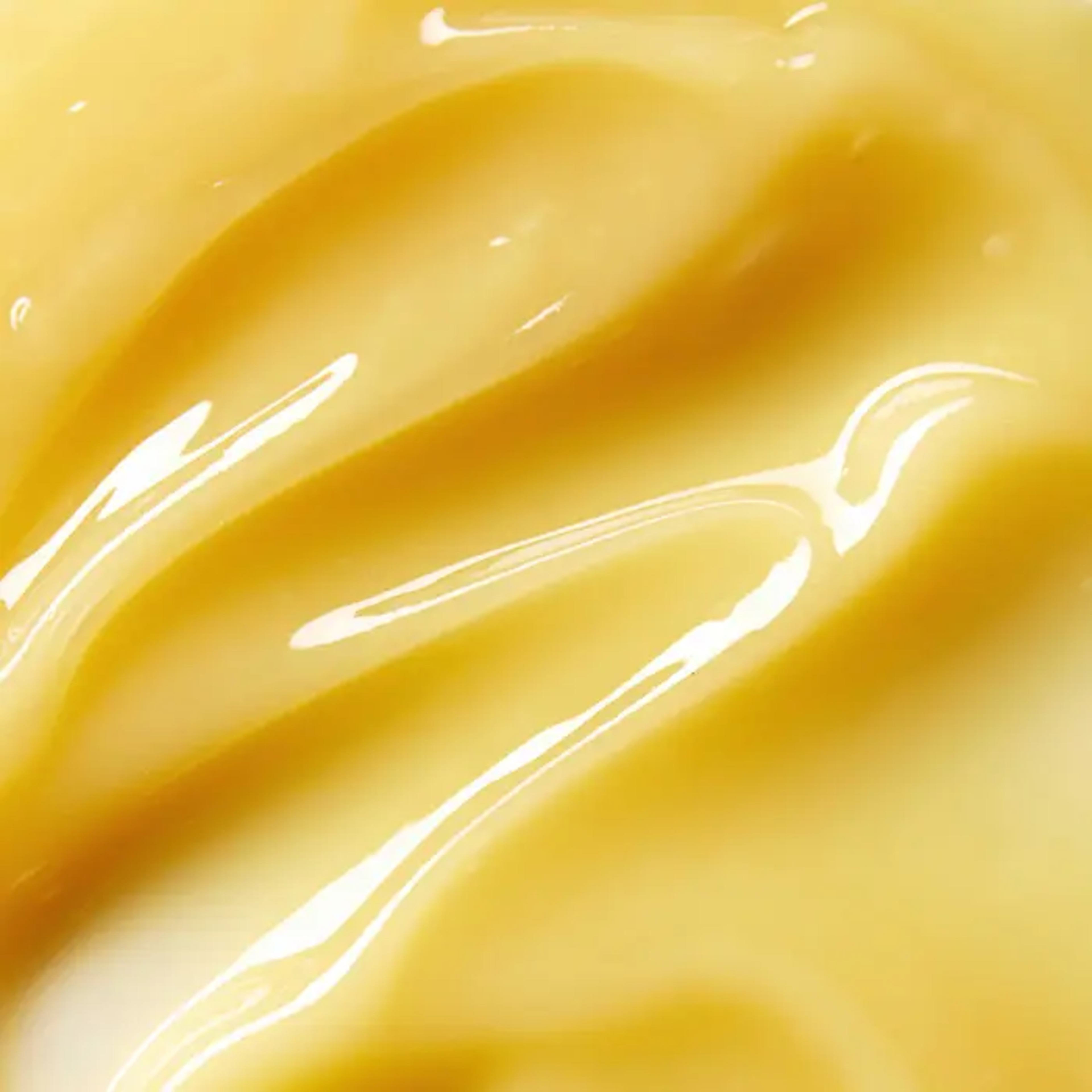 Crema giallo oro lucida con striature ondulate.