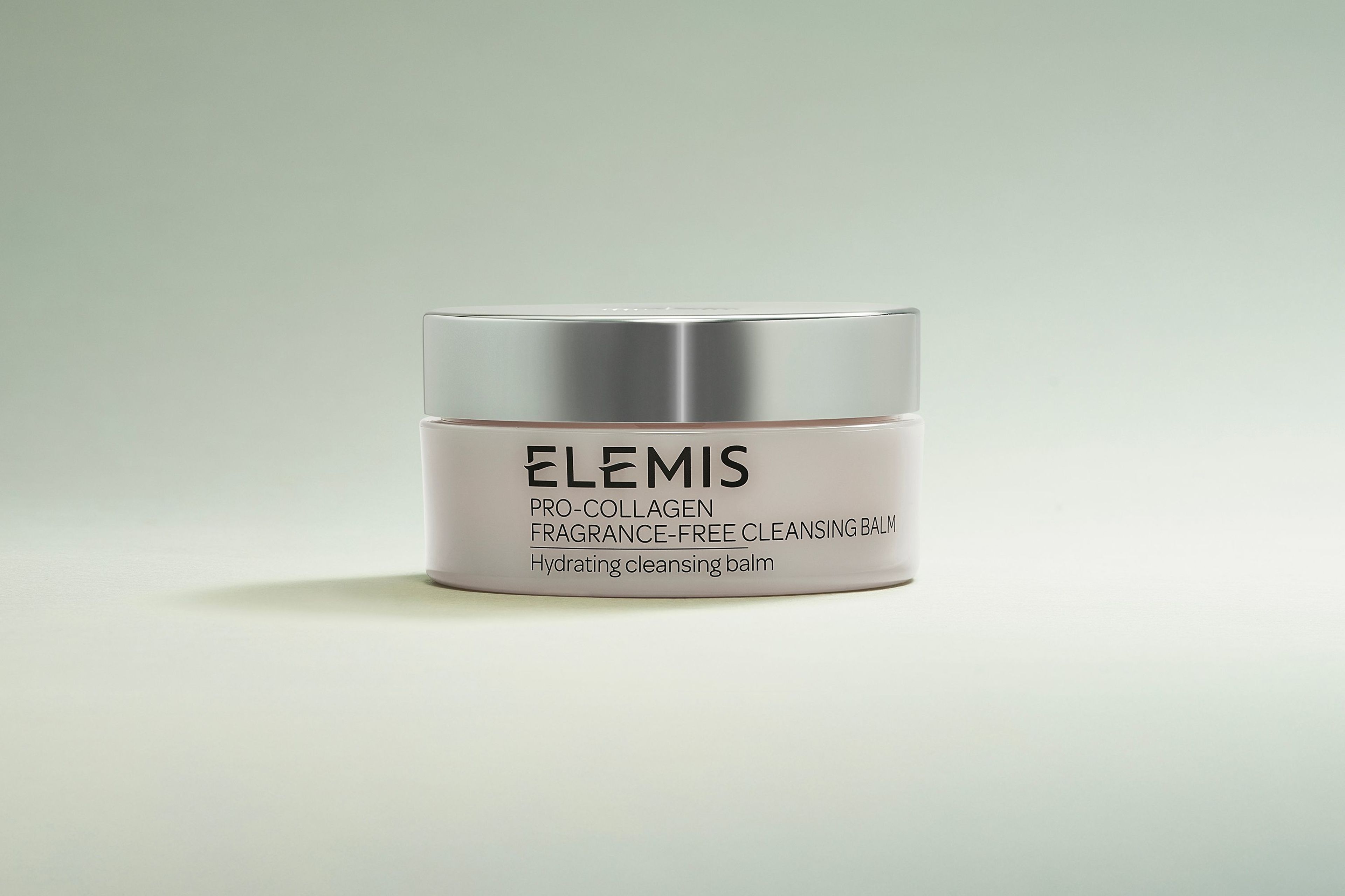 Open jar of Elemis Pro-Collagen Naked Cleansing Balm with the yellow balm visible.