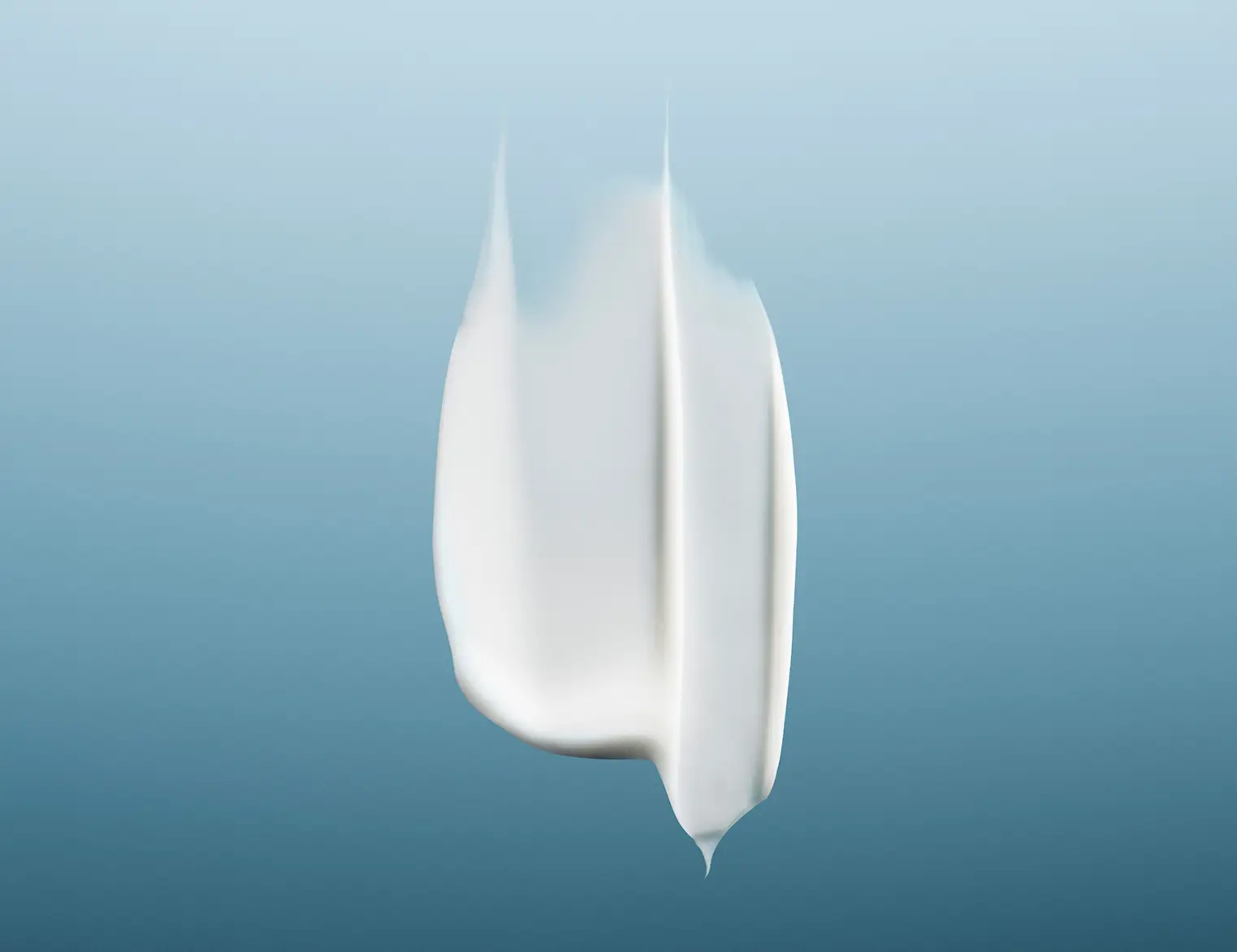 White cream swatch with a small drip on a blue background.