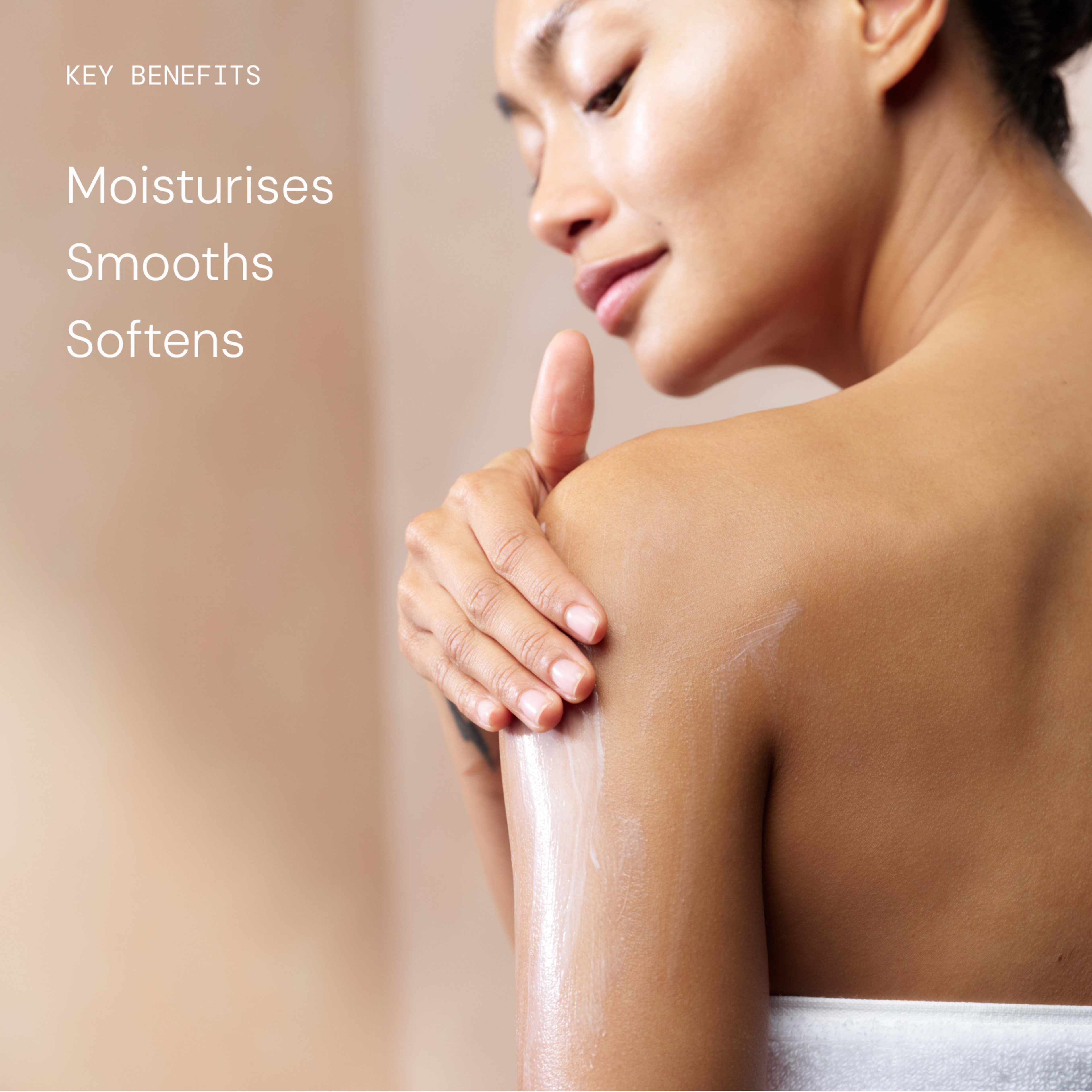Woman applying body lotion to her shoulder, with visible creamy swatch on her arm. Text on the left lists key benefits: “Moisturises, Smooths, Softens”.