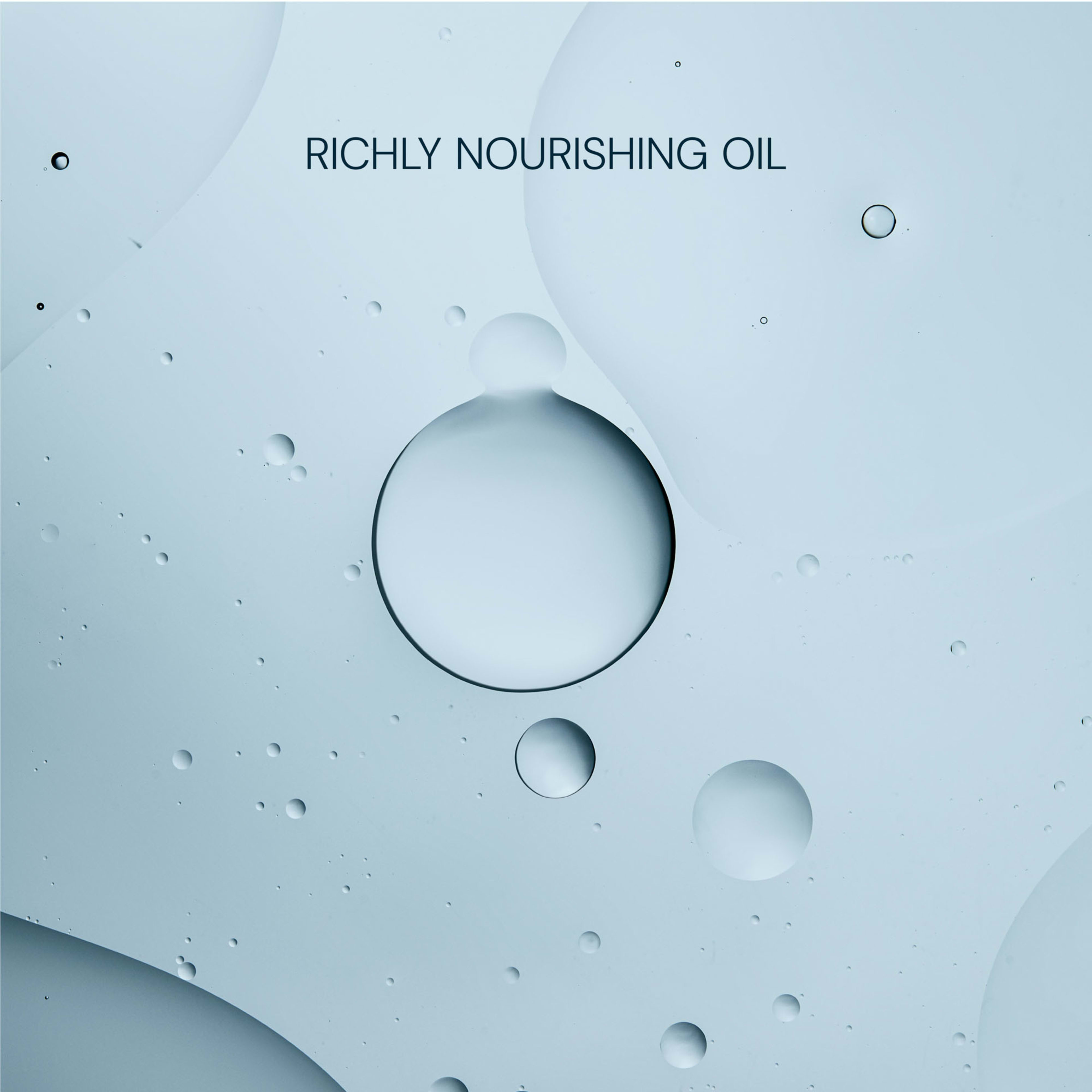 Text reading “Richly Nourishing Oil” over a pale blue background with abstract overlapping oil droplets