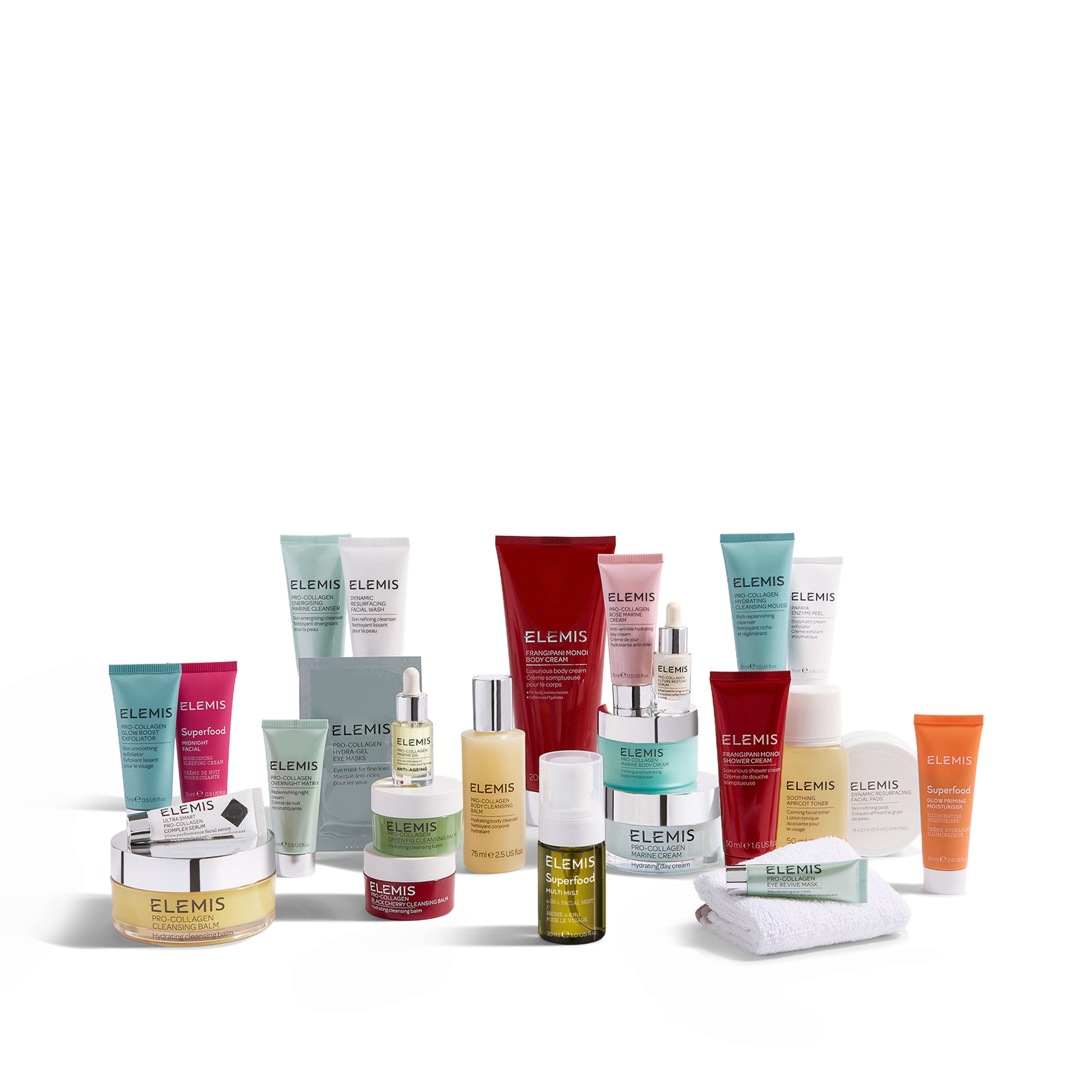 Range of ELEMIS skincare products arranged on a white surface, including cleansers, creams, serums, facial oil, body care, and gift-sized items in turquoise, red, yellow and orange packaging, with a folded white cloth and spatula in the foreground.