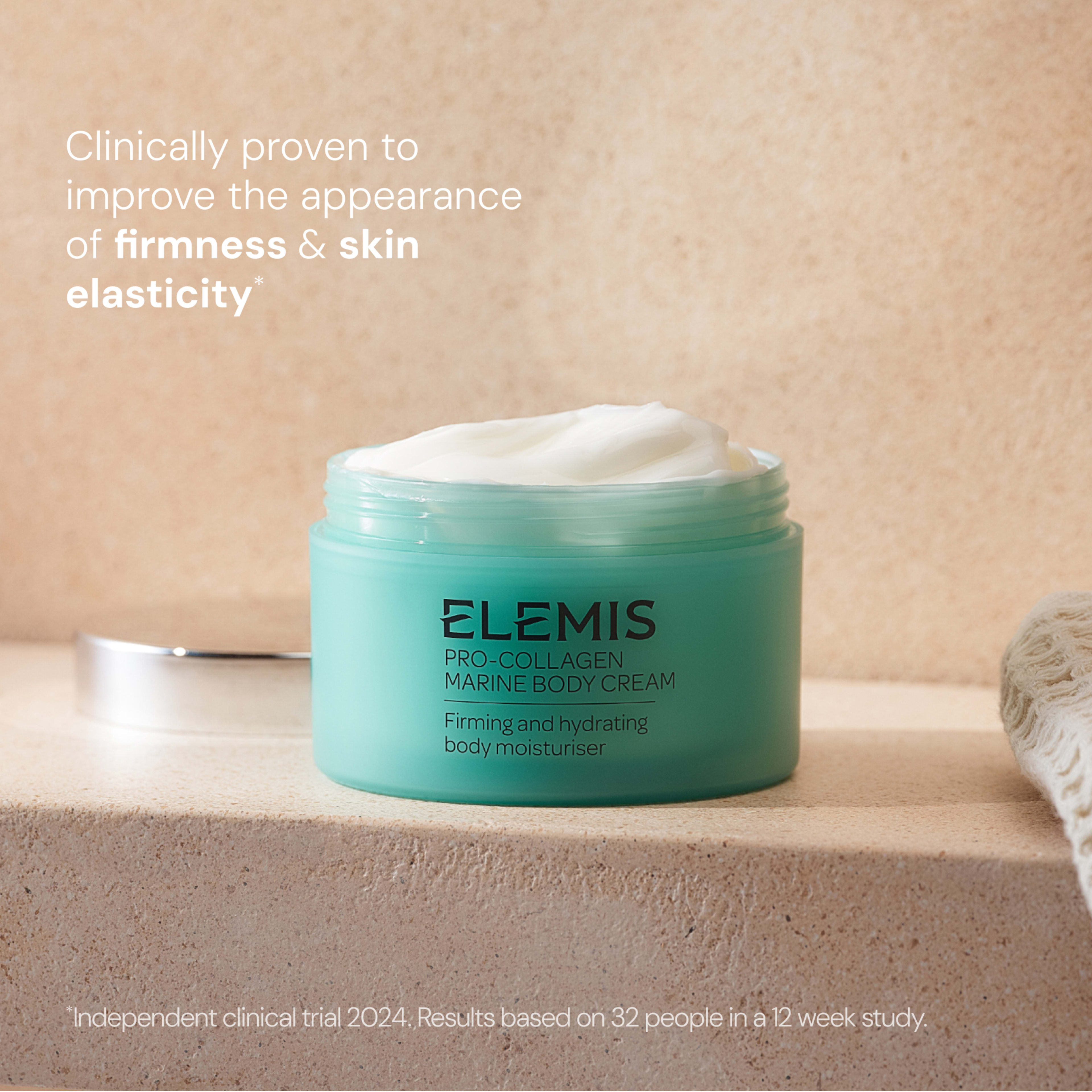 ELEMIS Pro-Collagen Marine Body Cream jar open to show white cream on a bathroom surface, with text stating it is clinically proven to improve the appearance of firmness and skin elasticity, based on a 12 week independent clinical trial of 32 people.