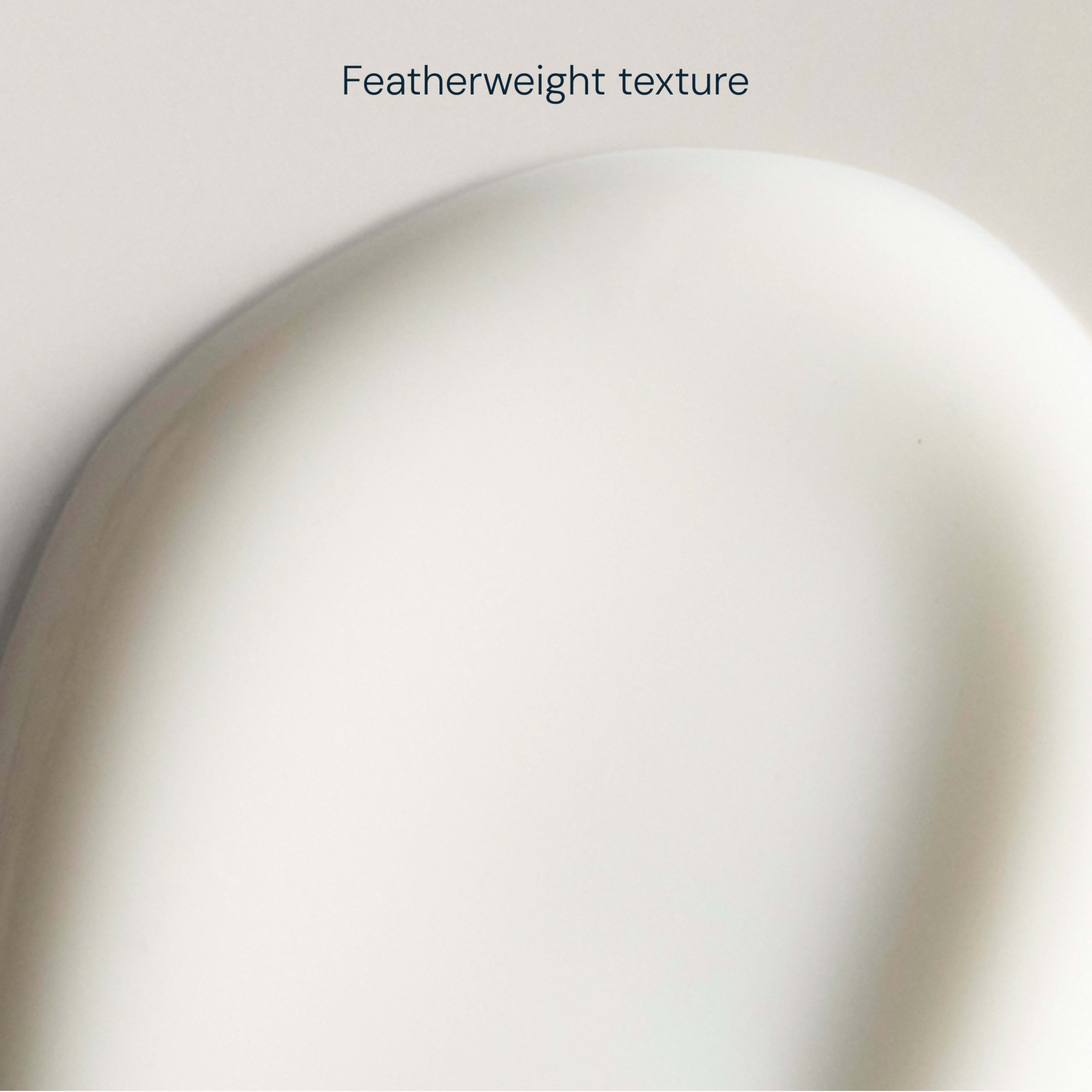Close-up swatch of a smooth white cream against a pale background, with the words "Featherweight texture" above, highlighting the product’s light, silky consistency.