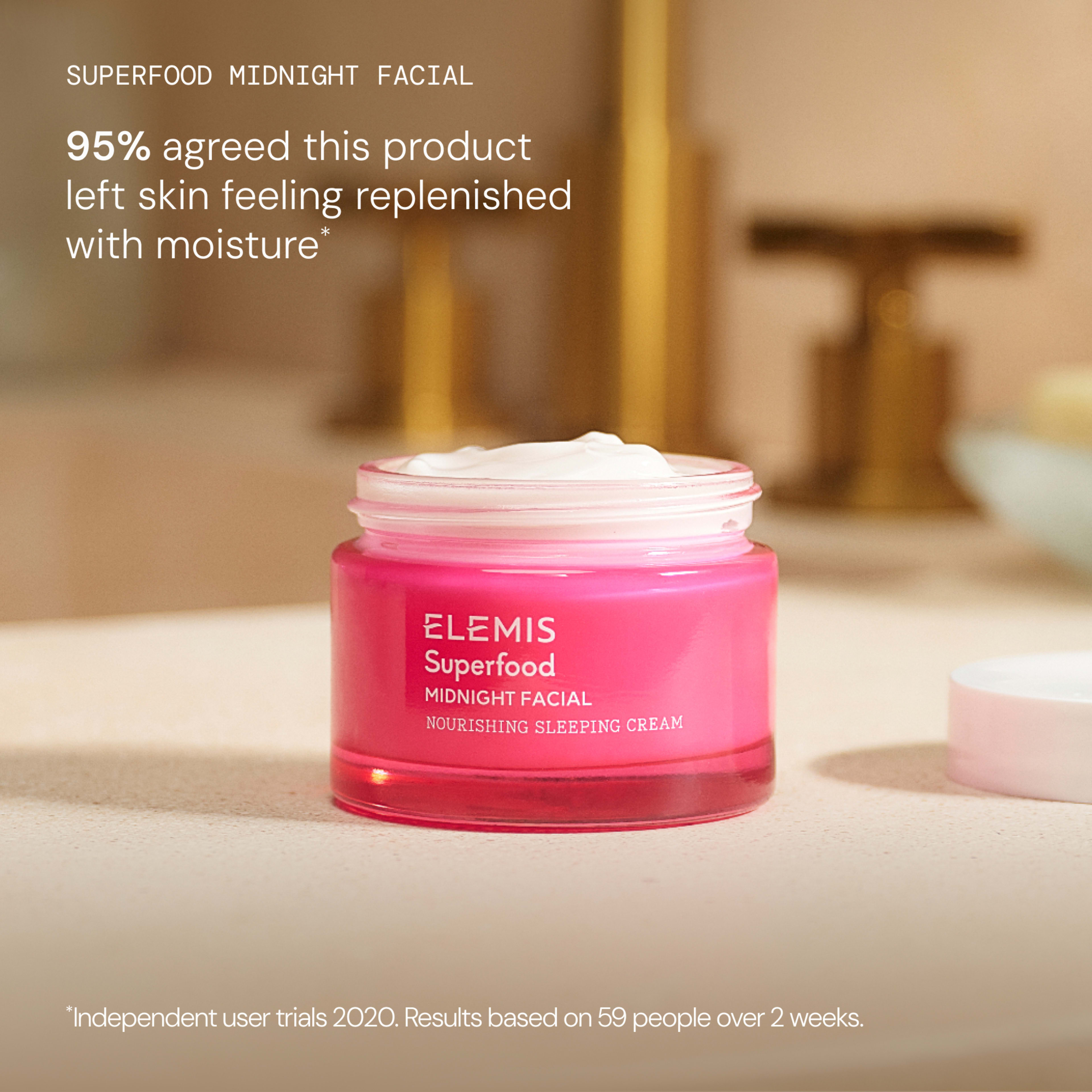 Pink jar of ELEMIS Superfood Midnight Facial nourishing sleeping cream on a bathroom counter with its lid off, whipped cream texture visible. Text reads: “95% agreed this product left skin feeling replenished with moisture*”.