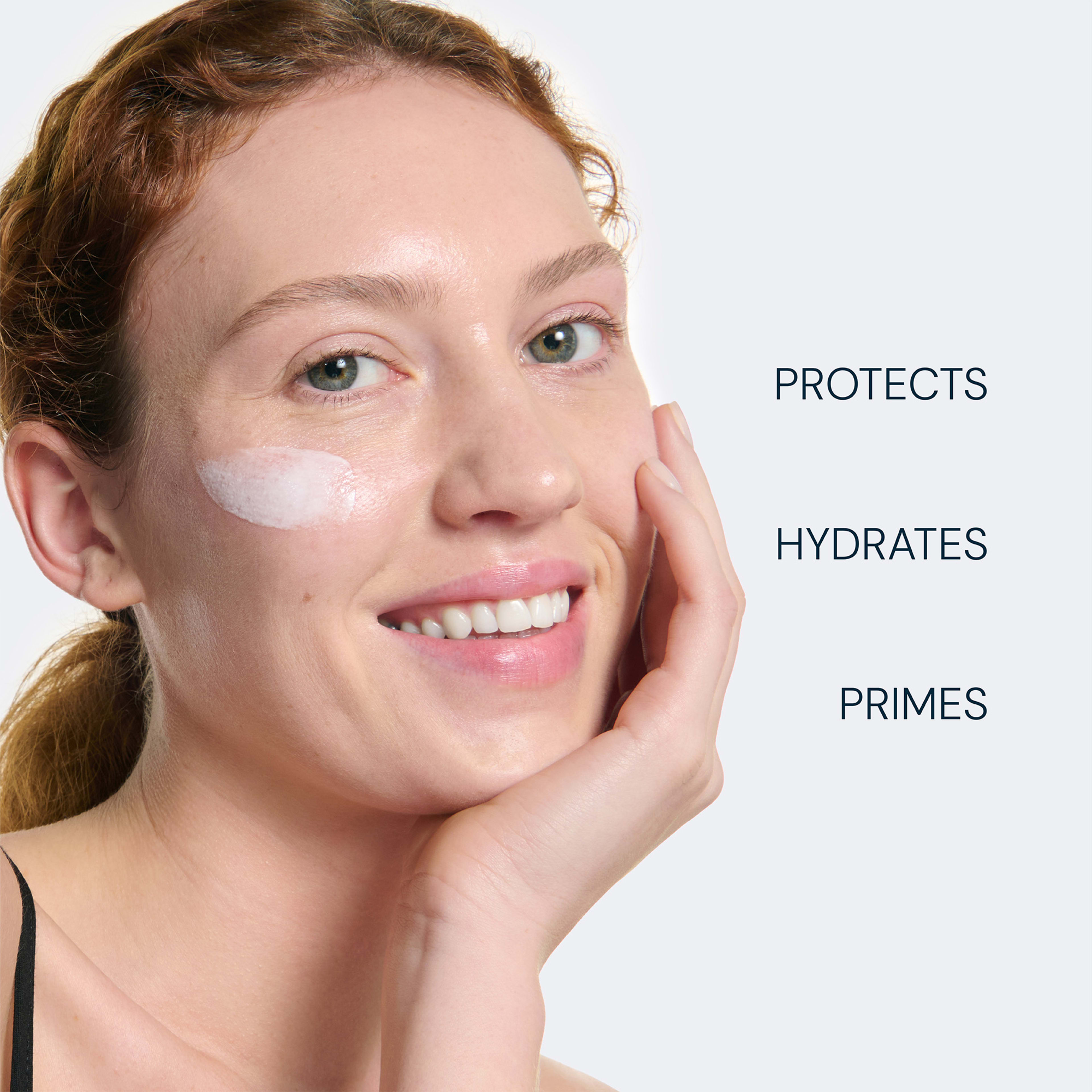 Smiling woman with a white skincare swatch on her cheek, gently touching her face. Text beside her reads: “PROTECTS”, “HYDRATES”, “PRIMES”, highlighting the benefits of the ELEMIS product.