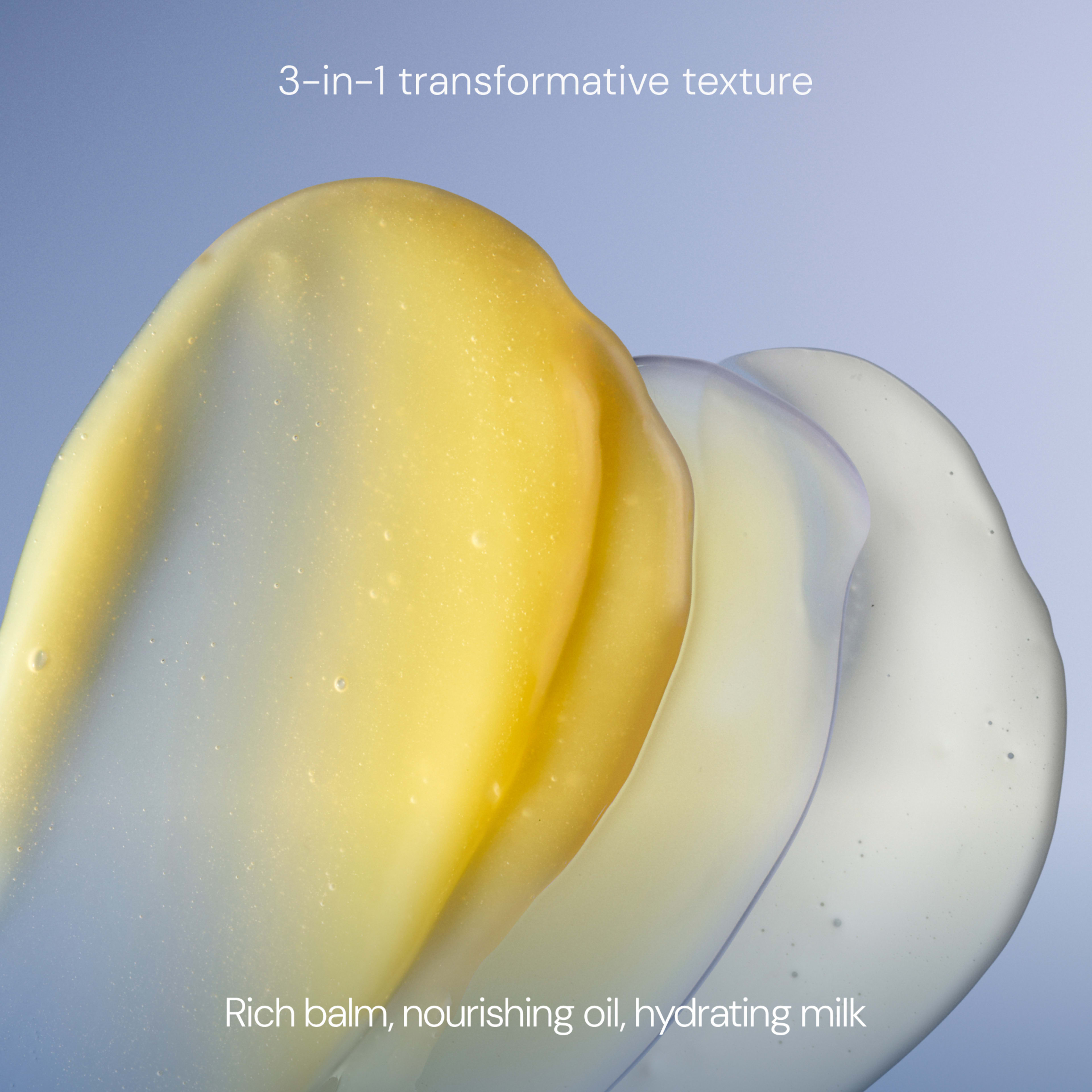 Three overlapping swatches of yellow balm, translucent oil and white milk textures on a soft blue background, with the text “3-in-1 transformative texture” and “Rich balm, nourishing oil, hydrating milk”.