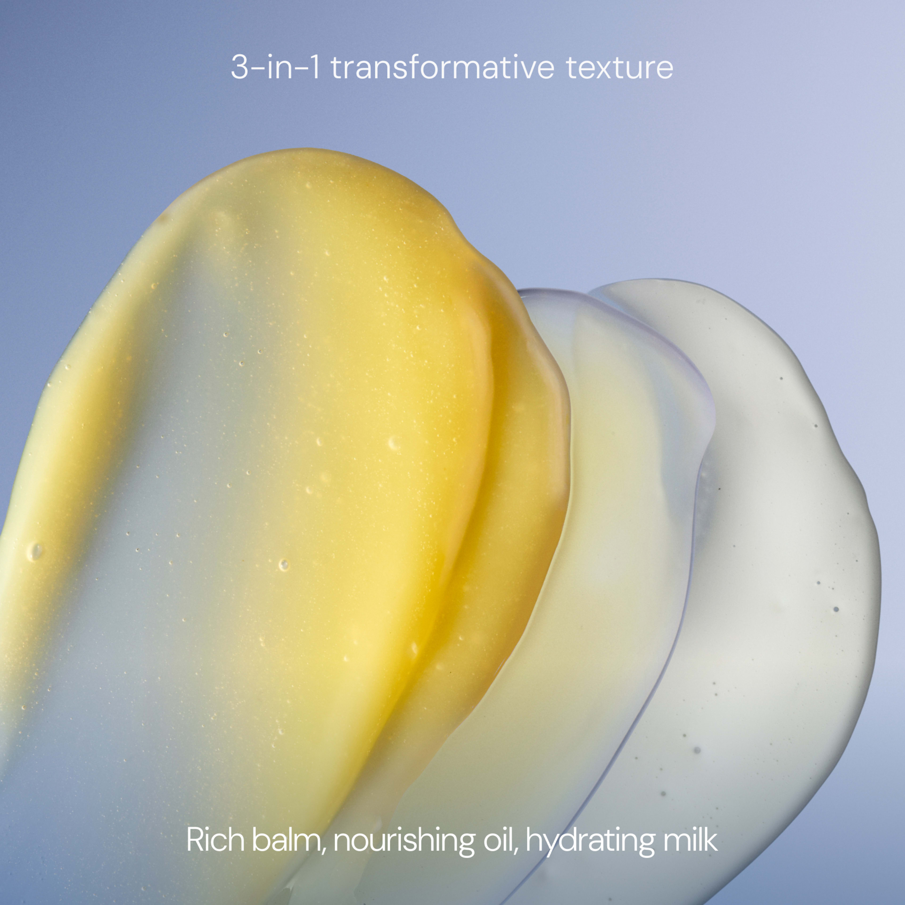 Three overlapping swatches of skincare textures on a blue background with the text “3-in-1 transformative texture”. Caption below reads “Rich balm, nourishing oil, hydrating milk”.