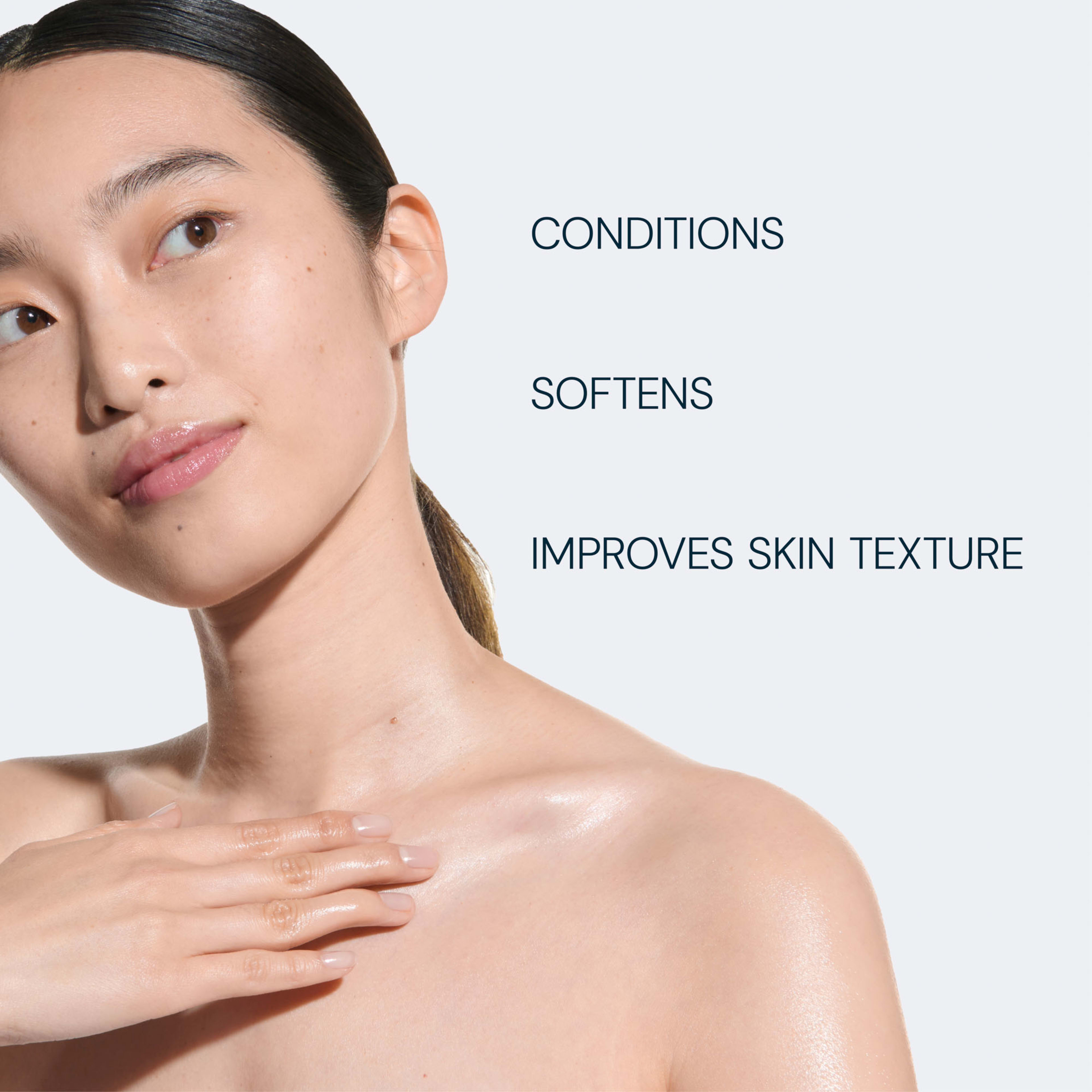 Woman with glowing bare skin touching her collarbone, looking to the side, promoting smooth, conditioned skin. Text reads: “CONDITIONS”, “SOFTENS”, “IMPROVES SKIN TEXTURE”.