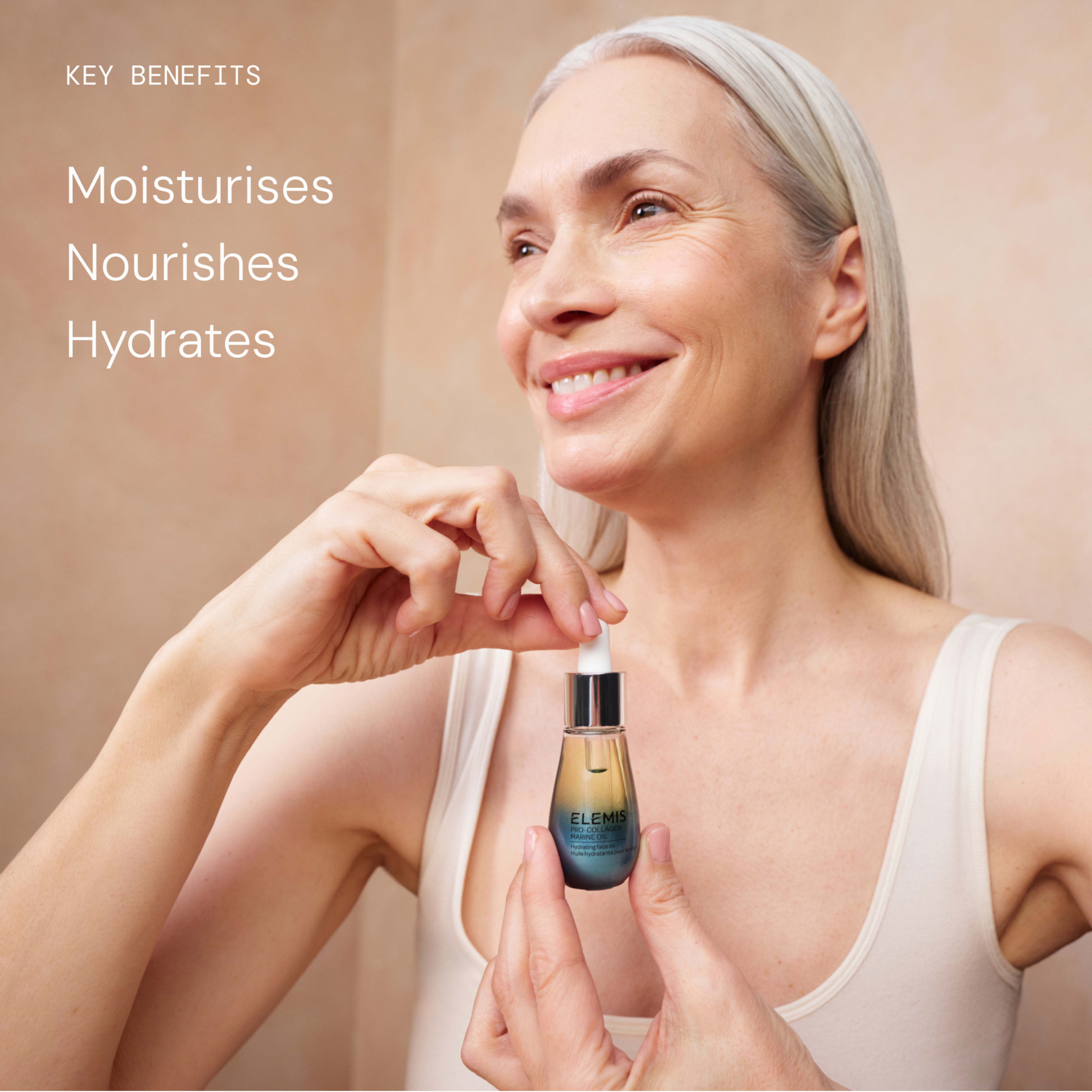 Smiling woman with long grey hair holds an ELEMIS facial serum with dropper against a neutral bathroom background. On the left, text reads: “Key benefits: Moisturises, Nourishes, Hydrates.”