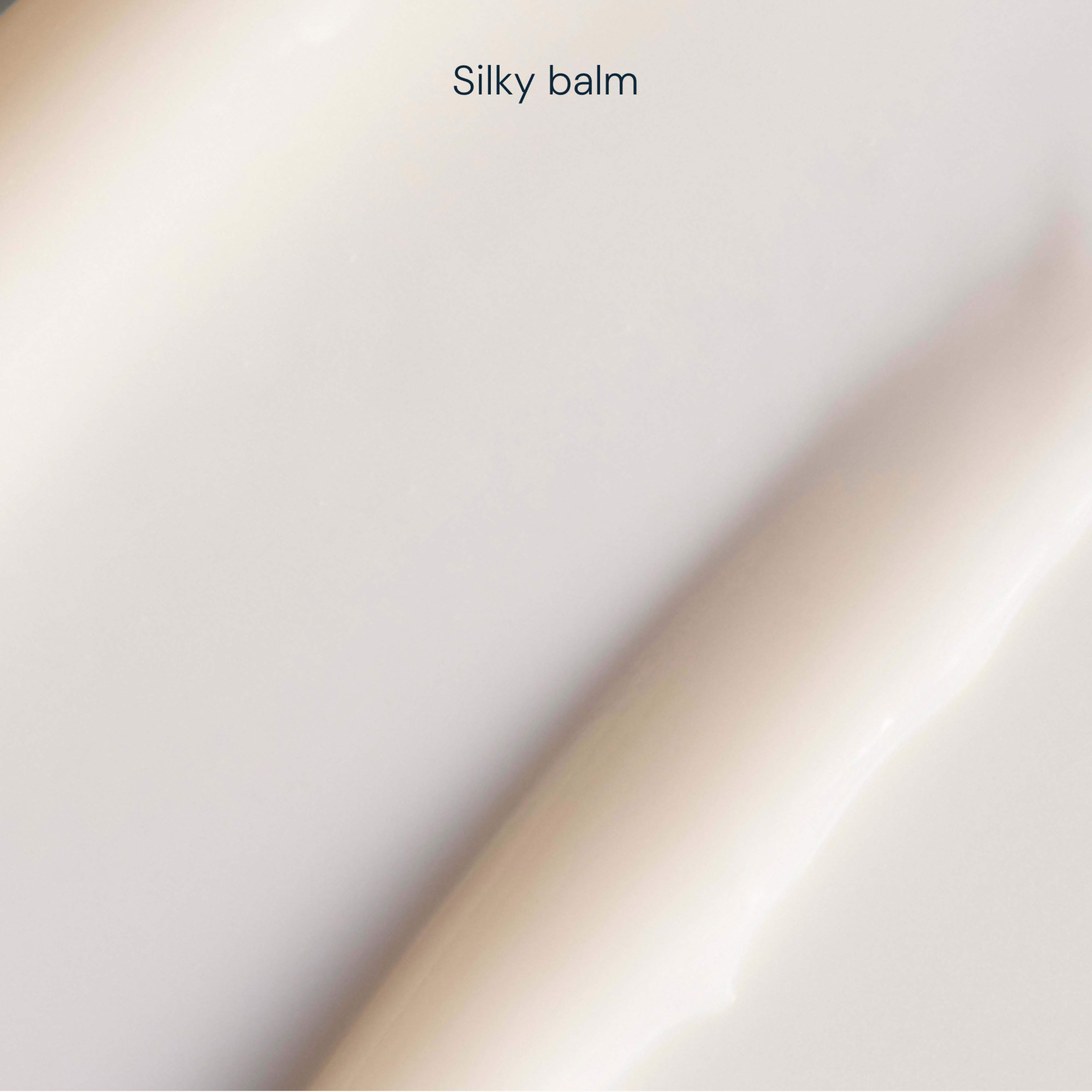 Creamy, pale beige swatch of silky balm texture shown in close up, with the words "Silky balm" at the top.