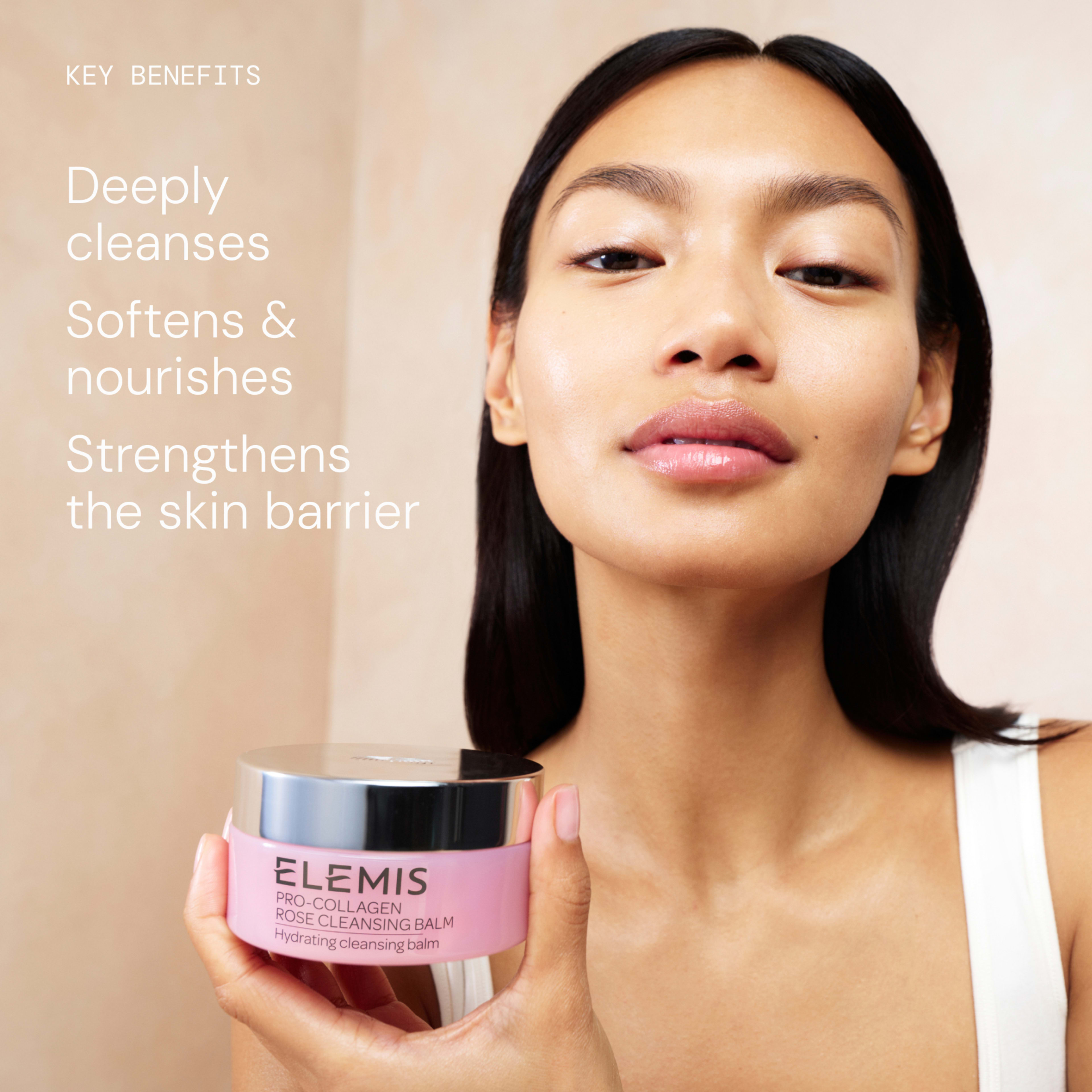 Woman with glowing skin holds a pink jar of ELEMIS Pro-Collagen Rose Cleansing Balm towards the camera. On the left, text reads: “Key benefits: Deeply cleanses, Softens & nourishes, Strengthens the skin barrier.”