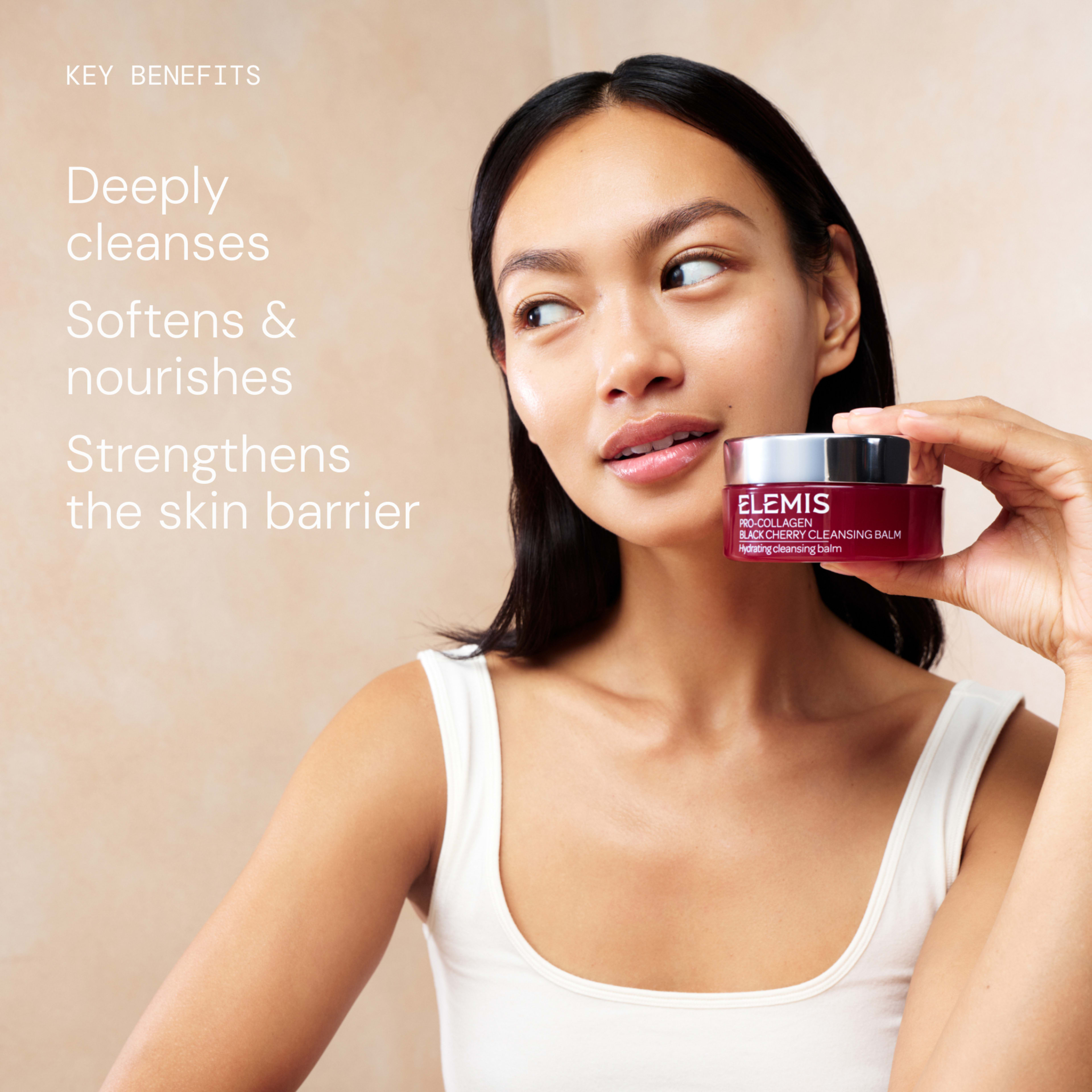 Woman holding a jar of ELEMIS Pro-Collagen Black Cherry Cleansing Balm, looking away with glowing bare skin. On the left, text reads: “Deeply cleanses; Softens & nourishes; Strengthens the skin barrier.”
