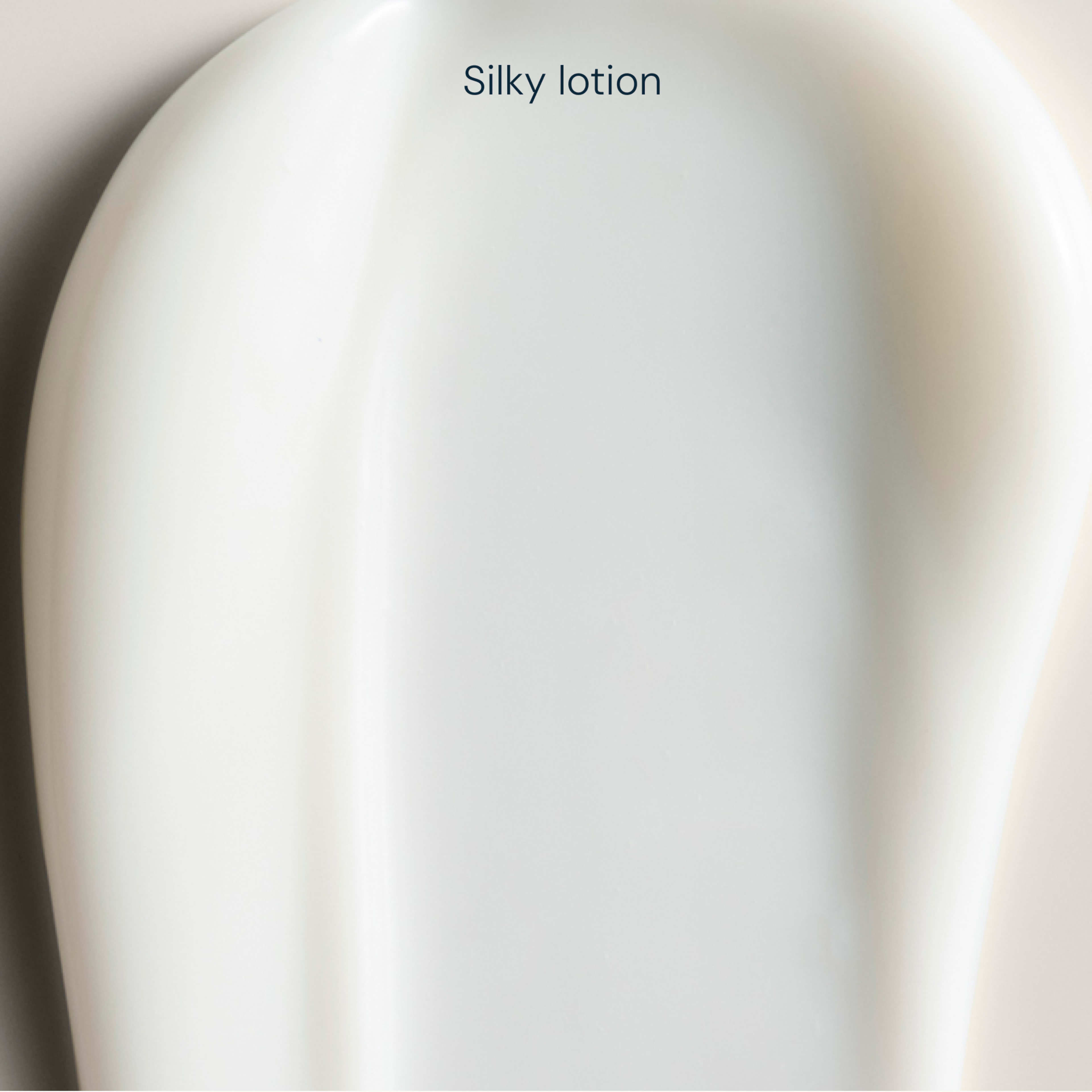 Close-up swatch of smooth white silky lotion, showing its creamy texture with the words “Silky lotion” at the top.