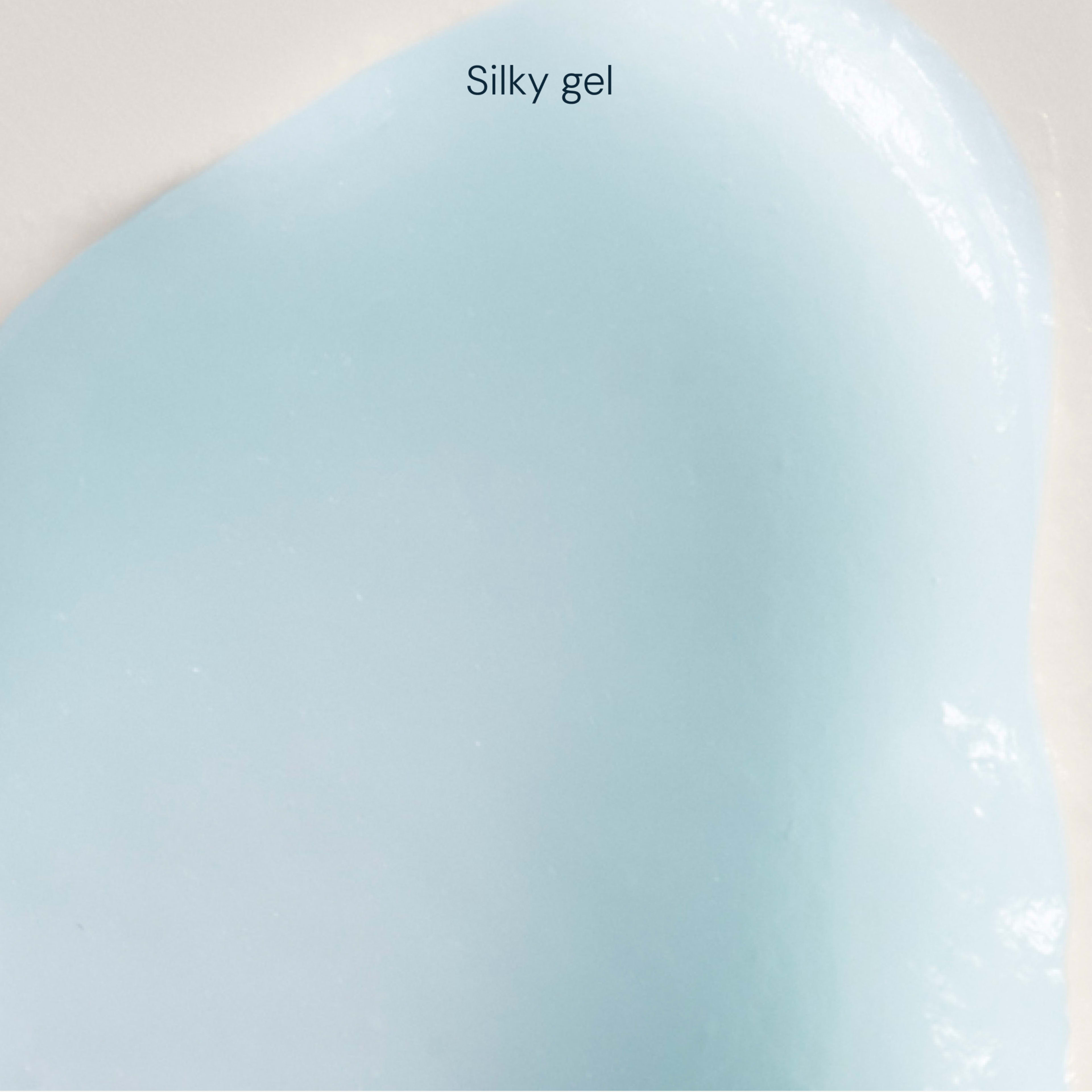 Close-up swatch of pale blue silky gel texture with a glossy, smooth finish.