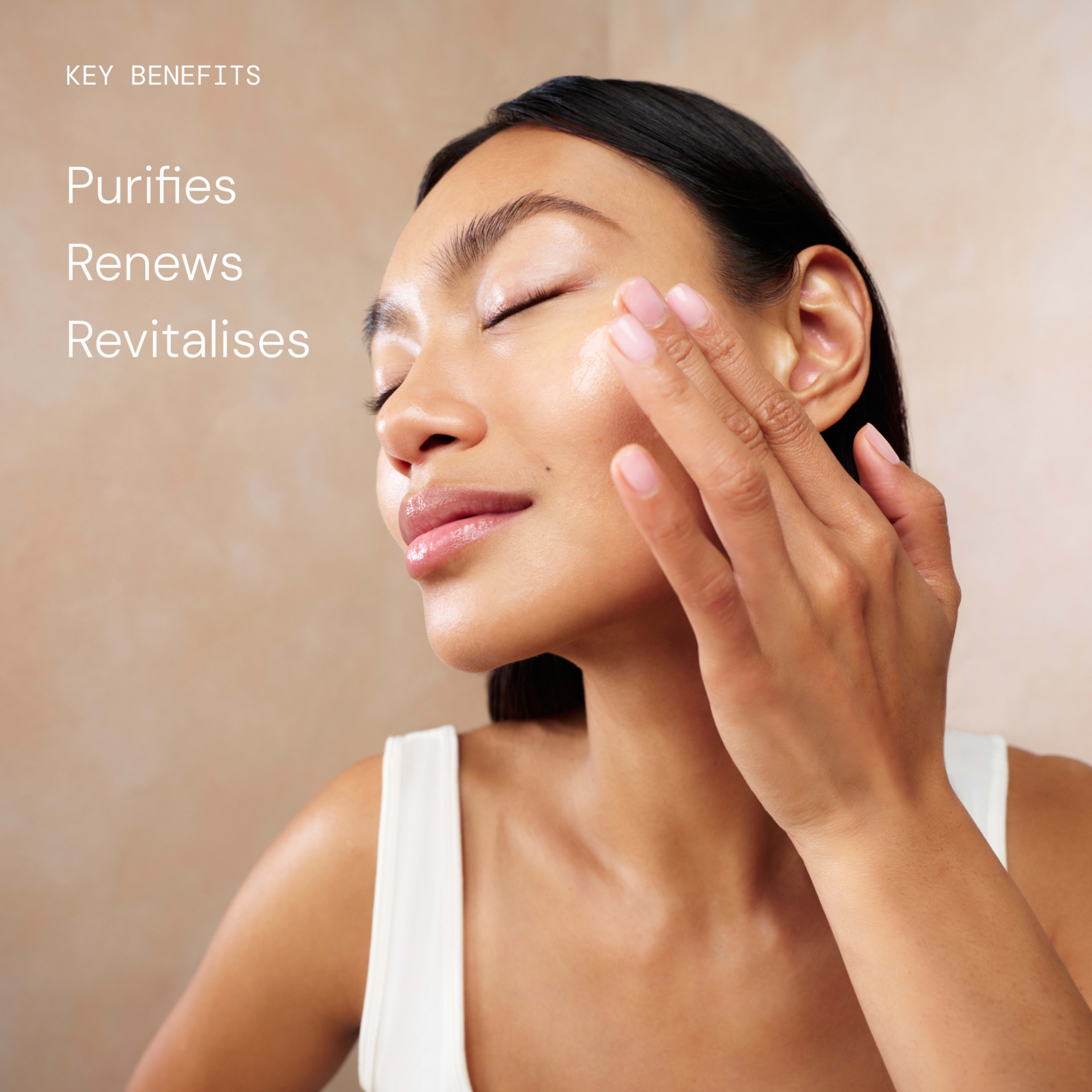 Woman gently applying skincare to her cheek with closed eyes, suggesting a soothing ELEMIS facial routine. On the left, white text reads: "KEY BENEFITS Purifies Renews Revitalises".