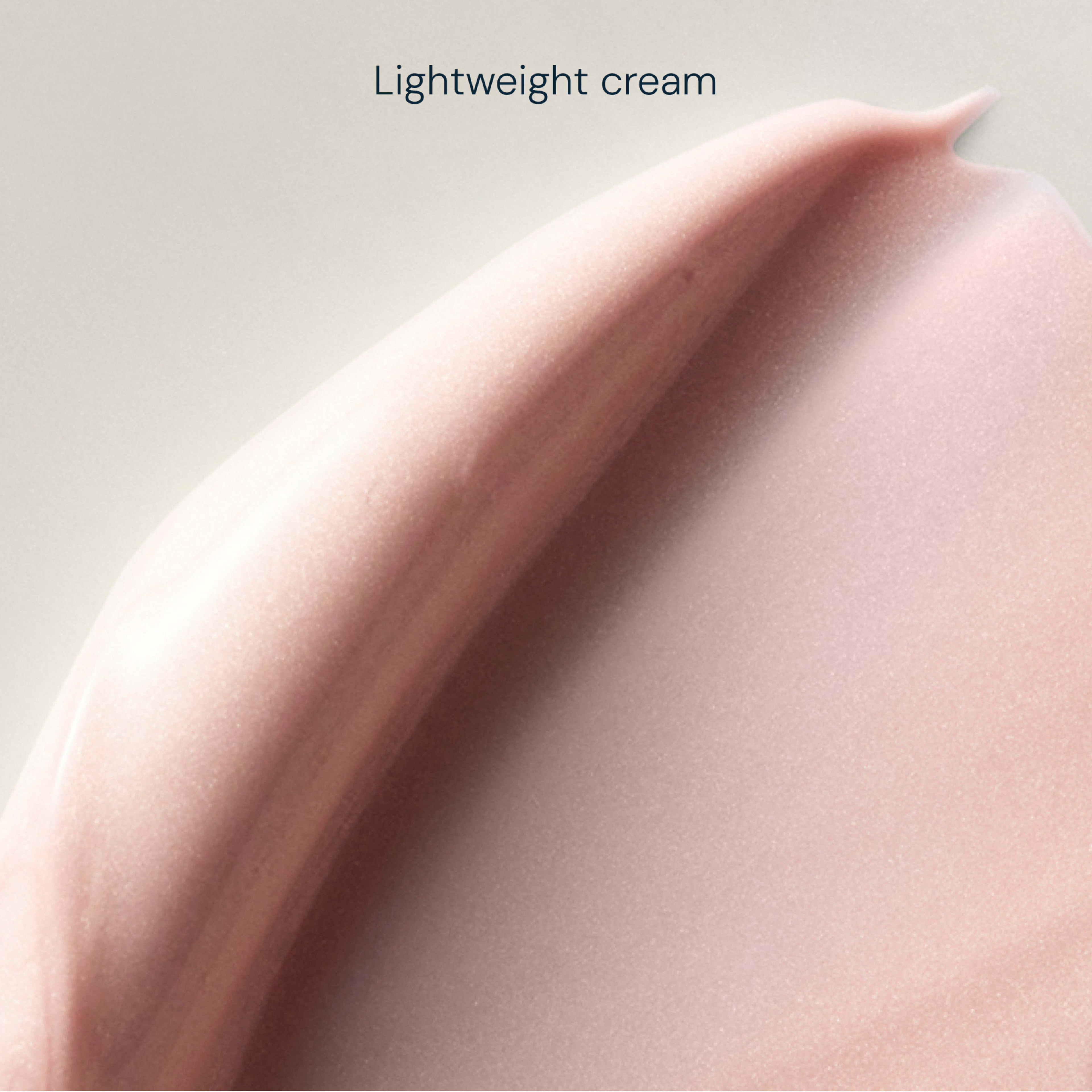Close-up swatch of pale pink lightweight cream with a smooth, silky texture, shown against a soft neutral background, with the words “Lightweight cream” at the top.