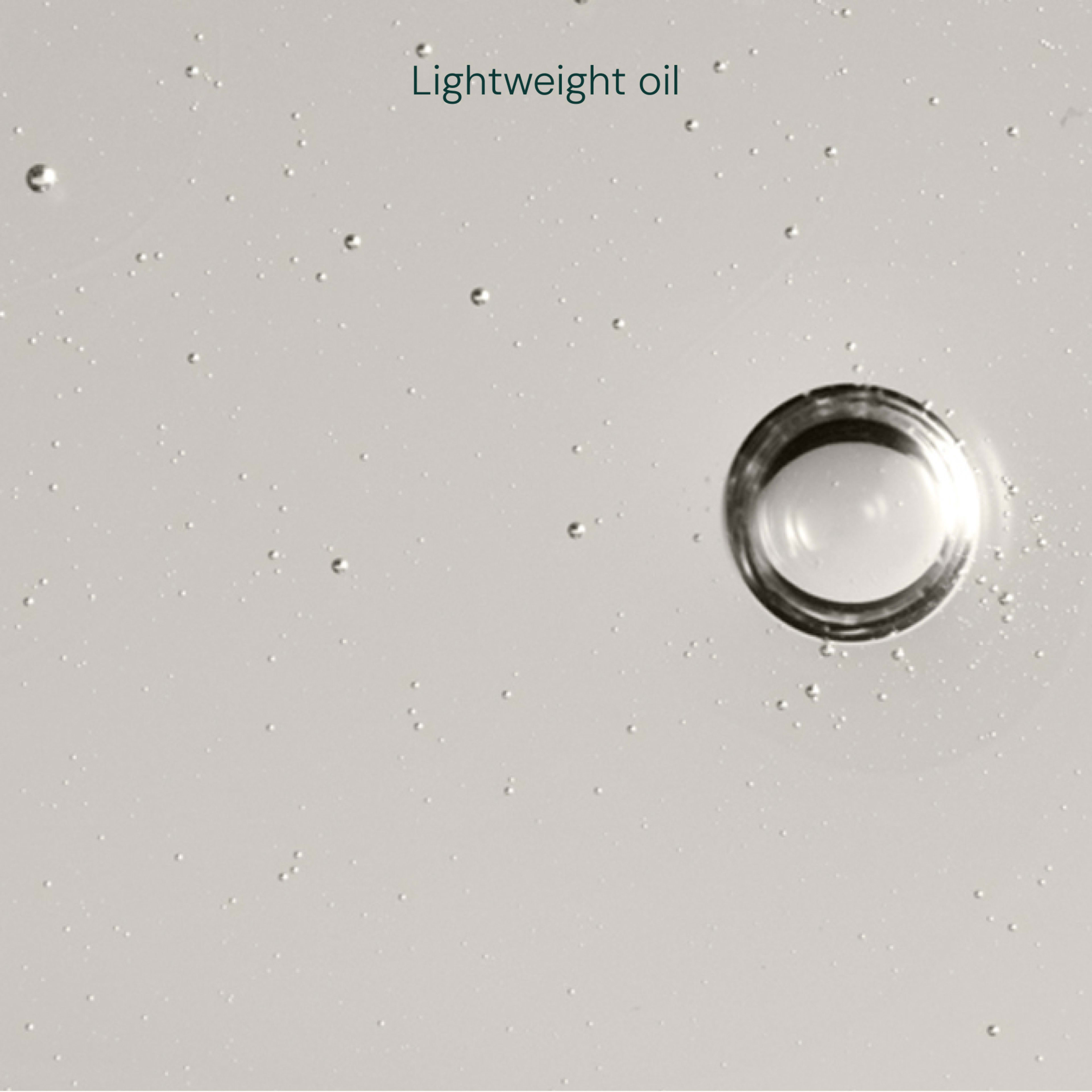 Large clear droplet of lightweight oil surrounded by tiny bubbles on a pale background, with the words "Lightweight oil" at the top.