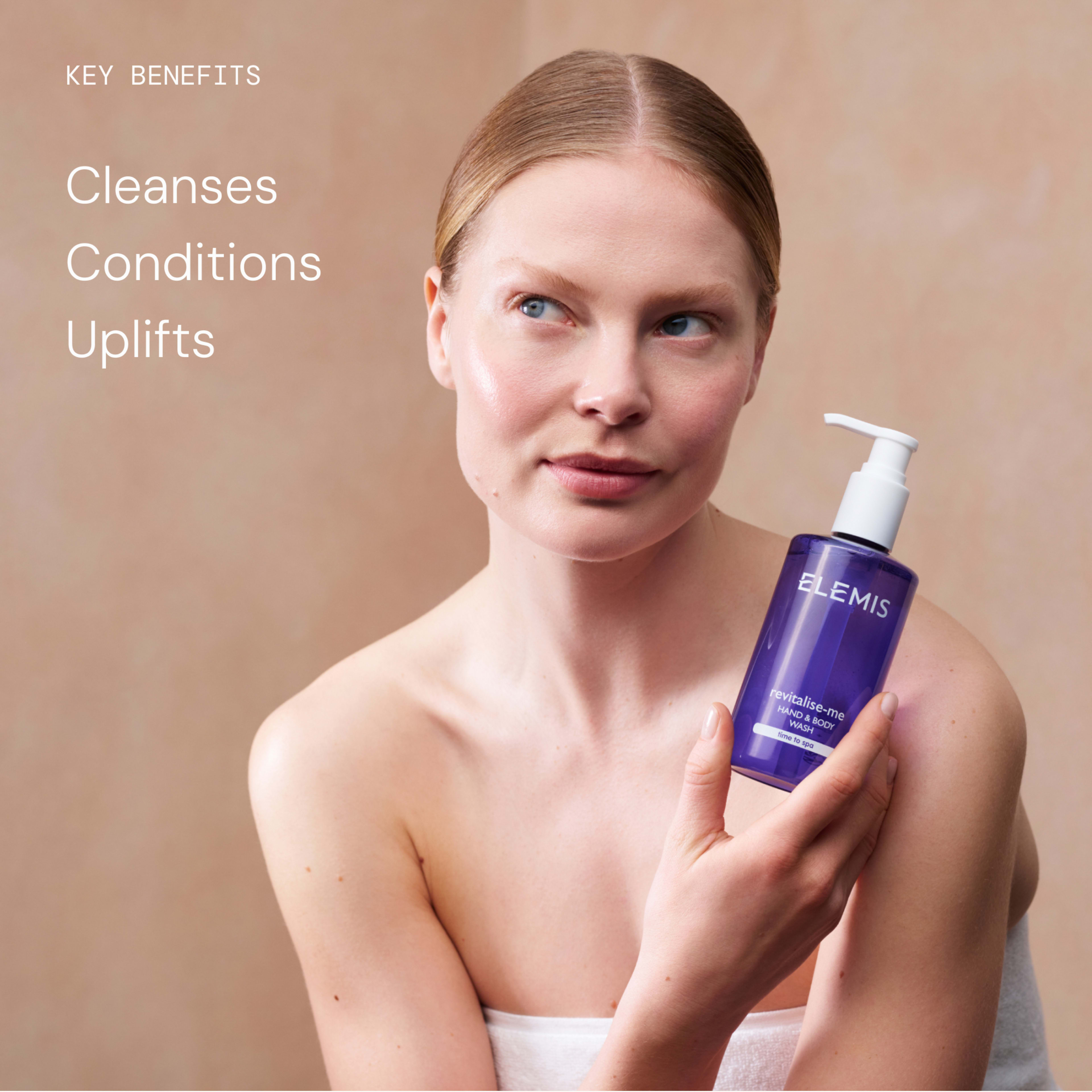 Woman with bare shoulders holds a purple bottle of ELEMIS Pro-Collagen Energising Marine Cleanser, looking to the side against a soft beige background. Text on the left reads: "Key benefits Cleanses Conditions Uplifts".