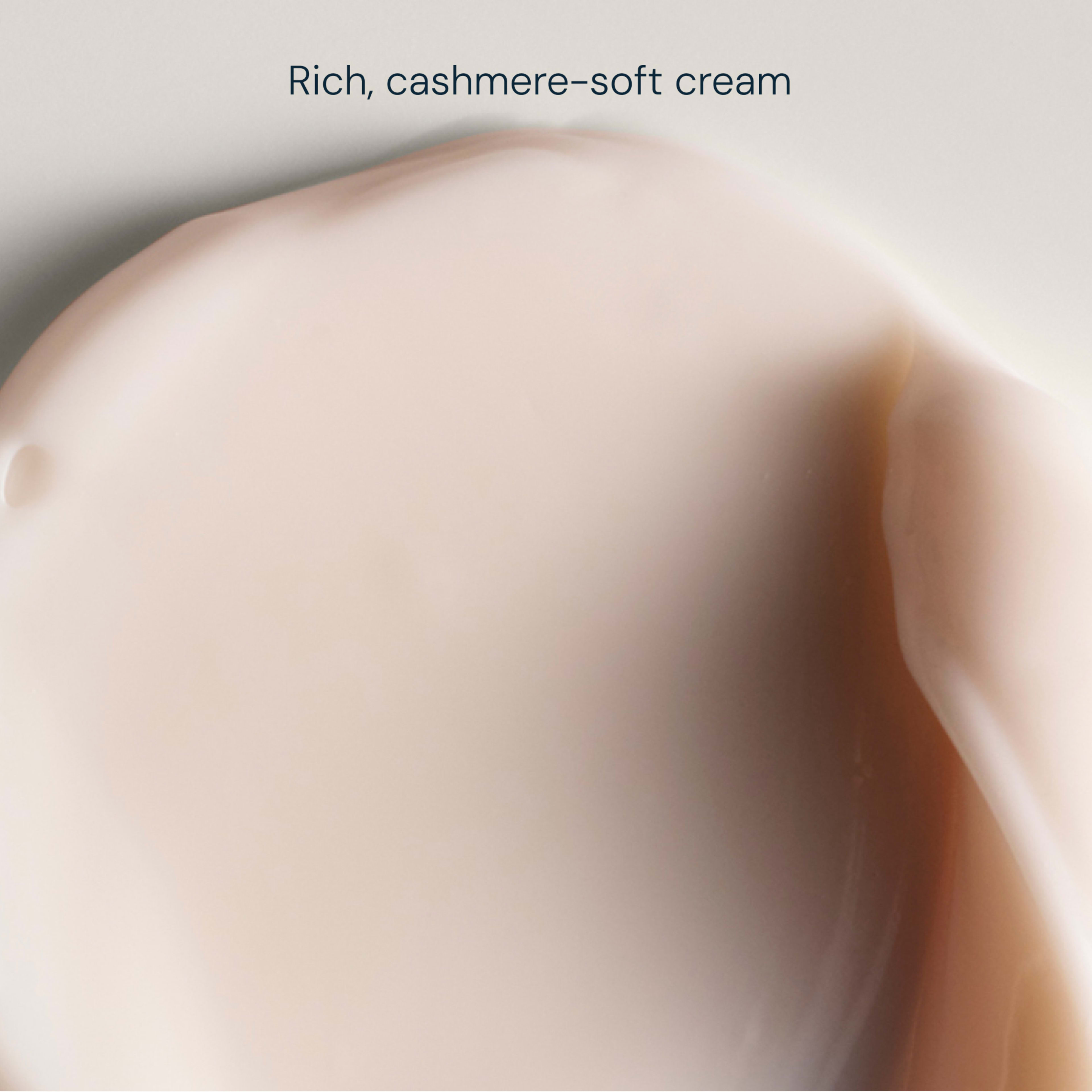 Close-up of a pale pink, rich, cashmere-soft cream, shown in a smooth, glossy swatch with the words "Rich, cashmere-soft cream" above.