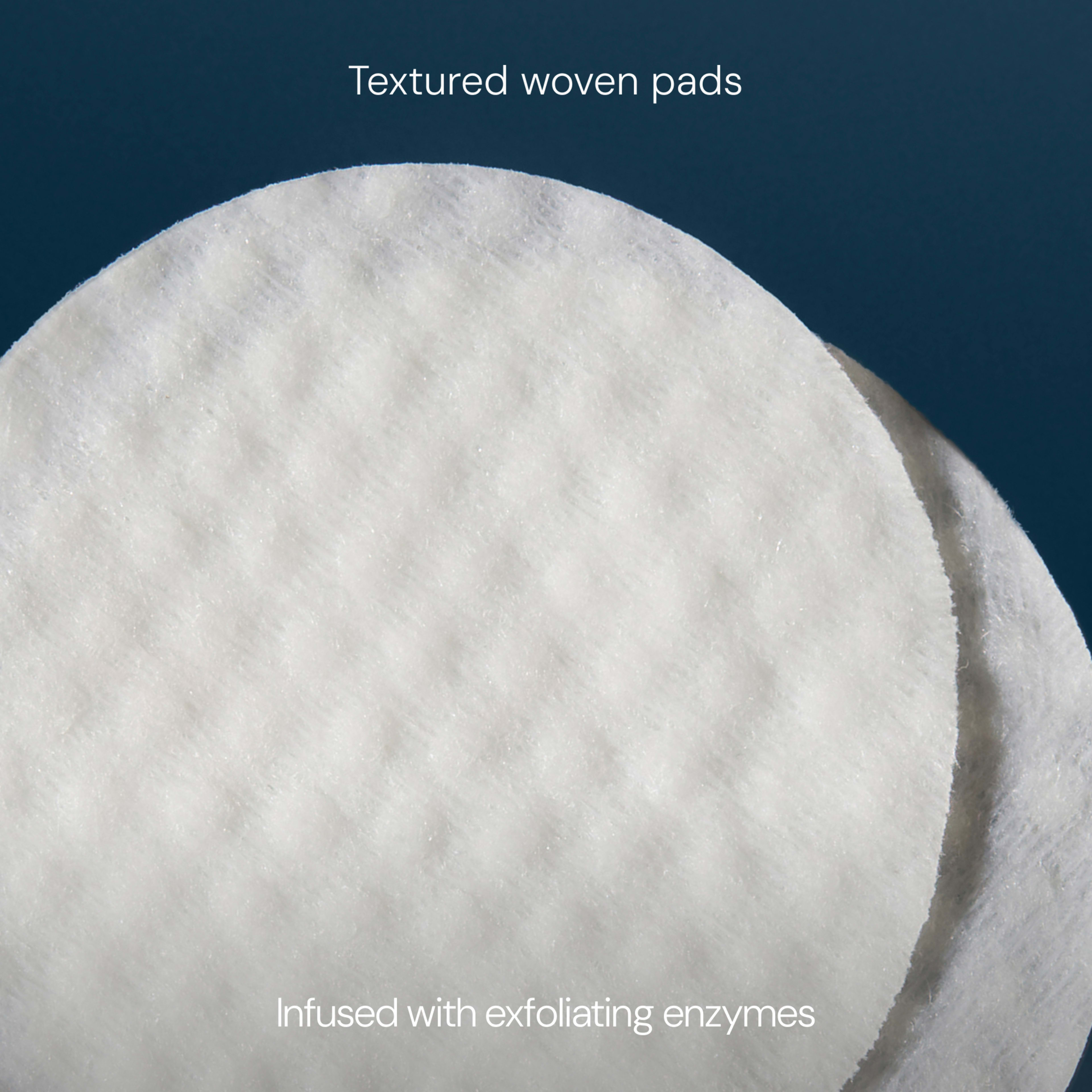 Close-up of white textured woven pads against a dark blue background, showing their soft dimpled surface. On-image text reads: "Textured woven pads" and "Infused with exfoliating enzymes".