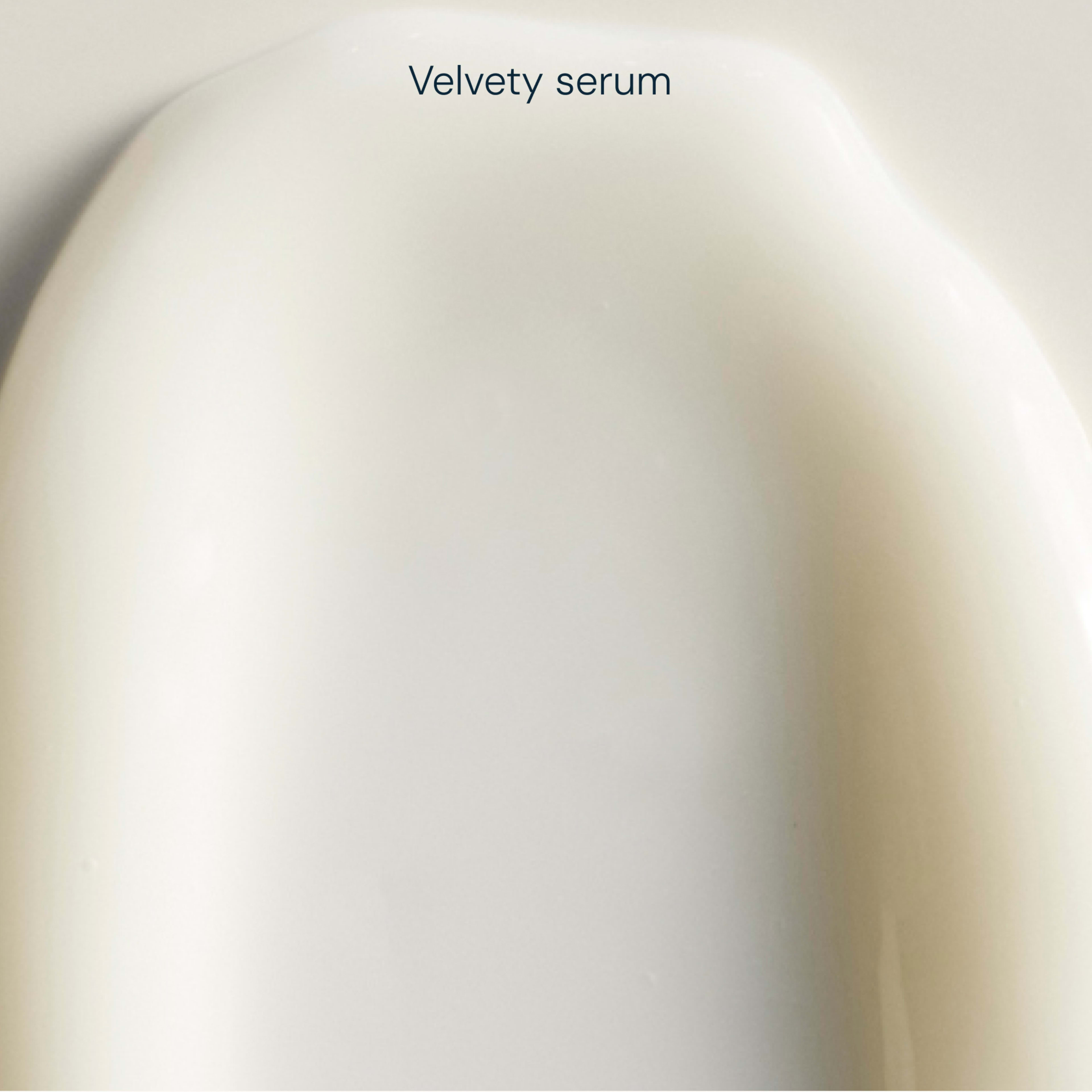 Close-up of a creamy white skincare swatch with the words "Velvety serum" above.