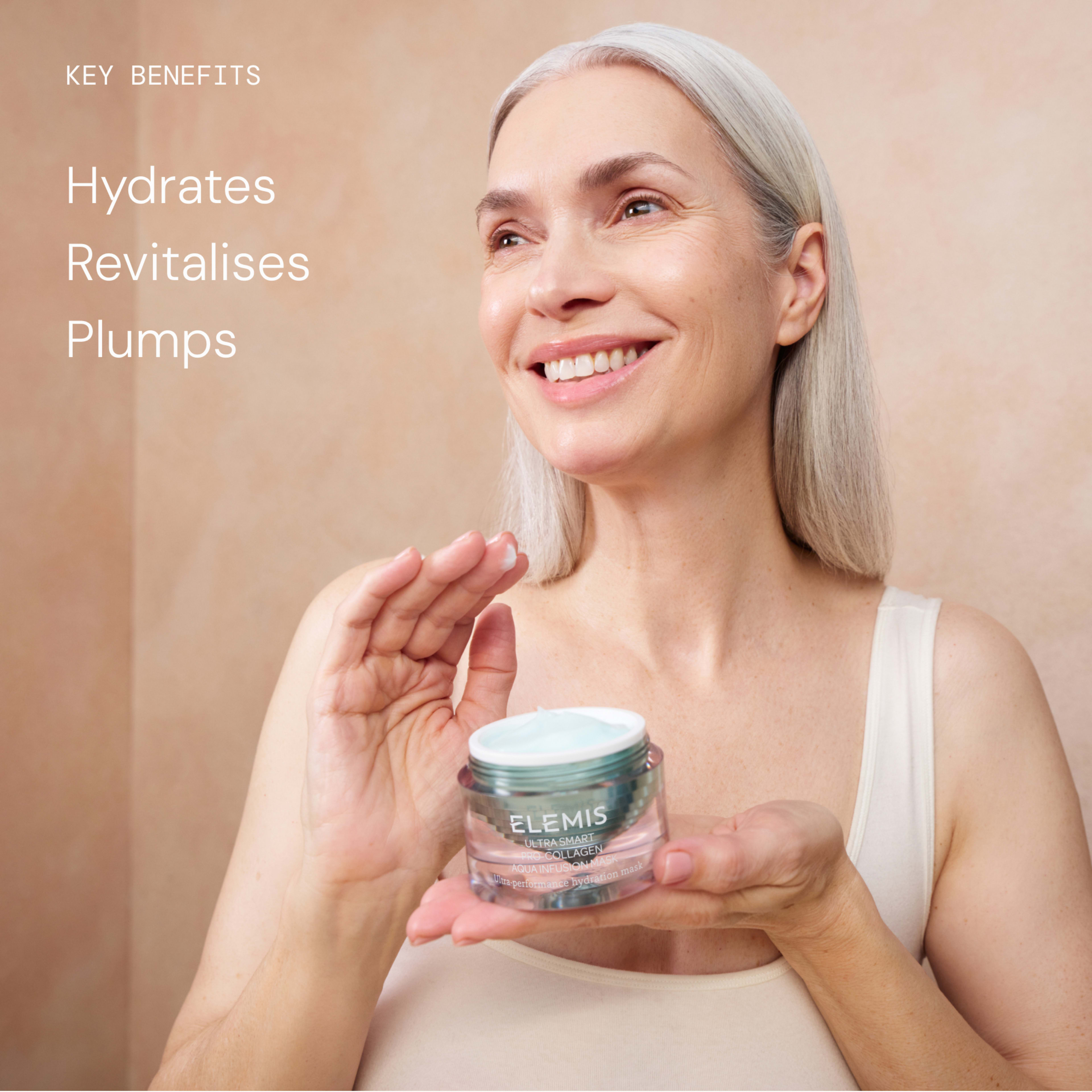 Smiling older woman holding an open ELEMIS face cream jar and gesturing as if applying it, against a soft neutral background. On the left, text reads: "Key benefits Hydrates Revitalises Plumps".