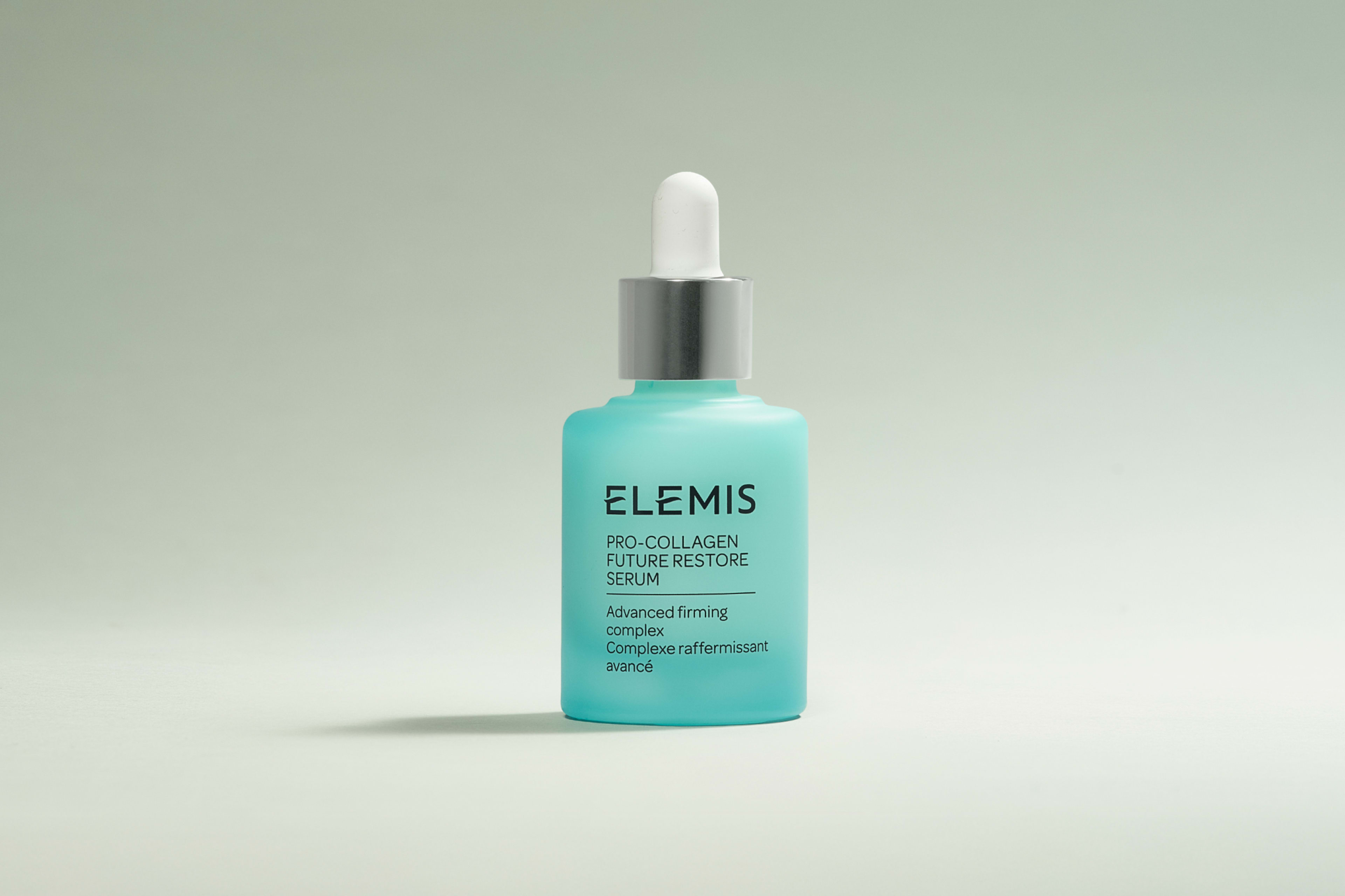 Elemis Pro-Collagen Future Restore Serum in a light blue dropper bottle with a drop of liquid.