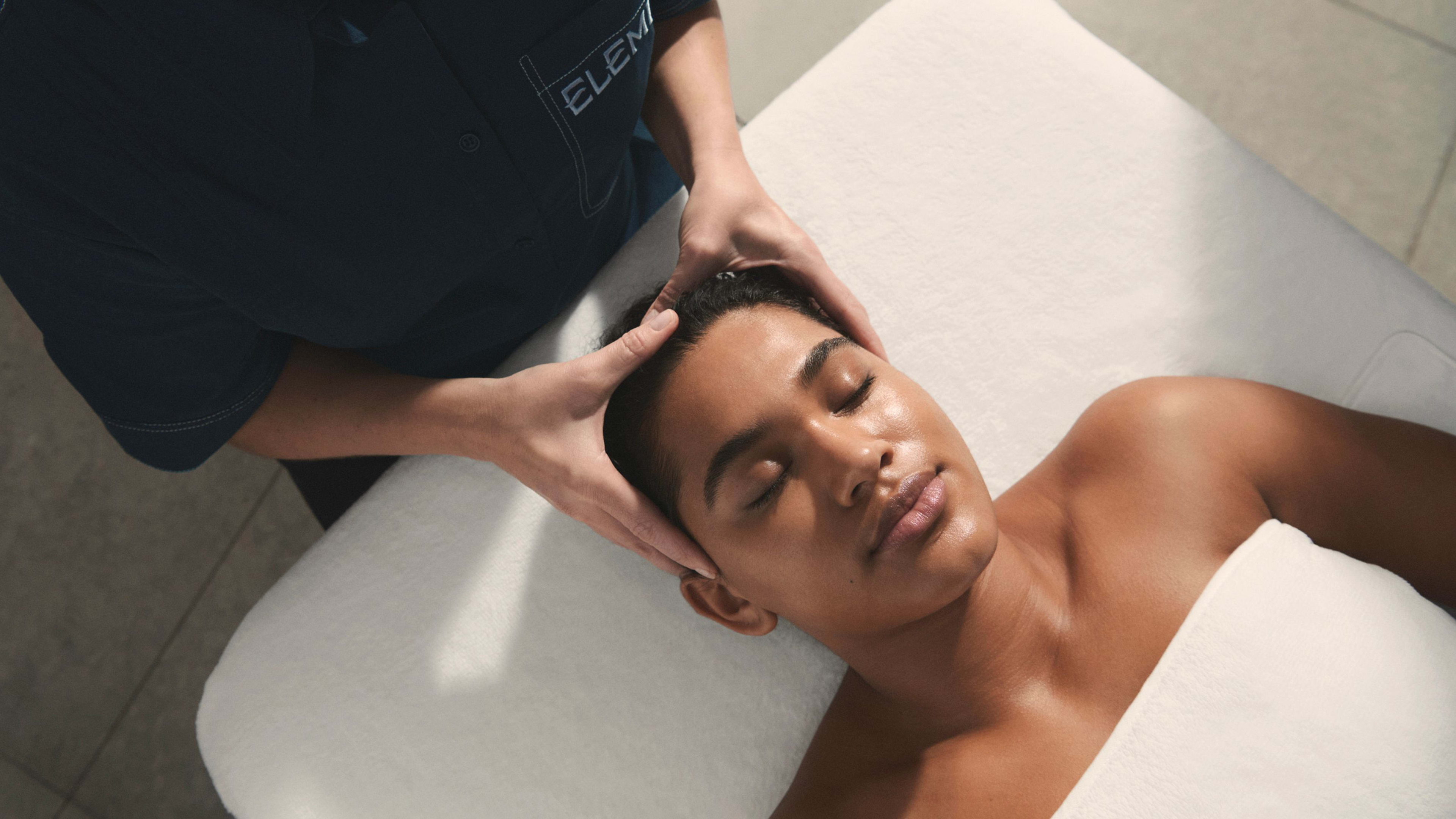 Woman having a facial massage as part of a treatment